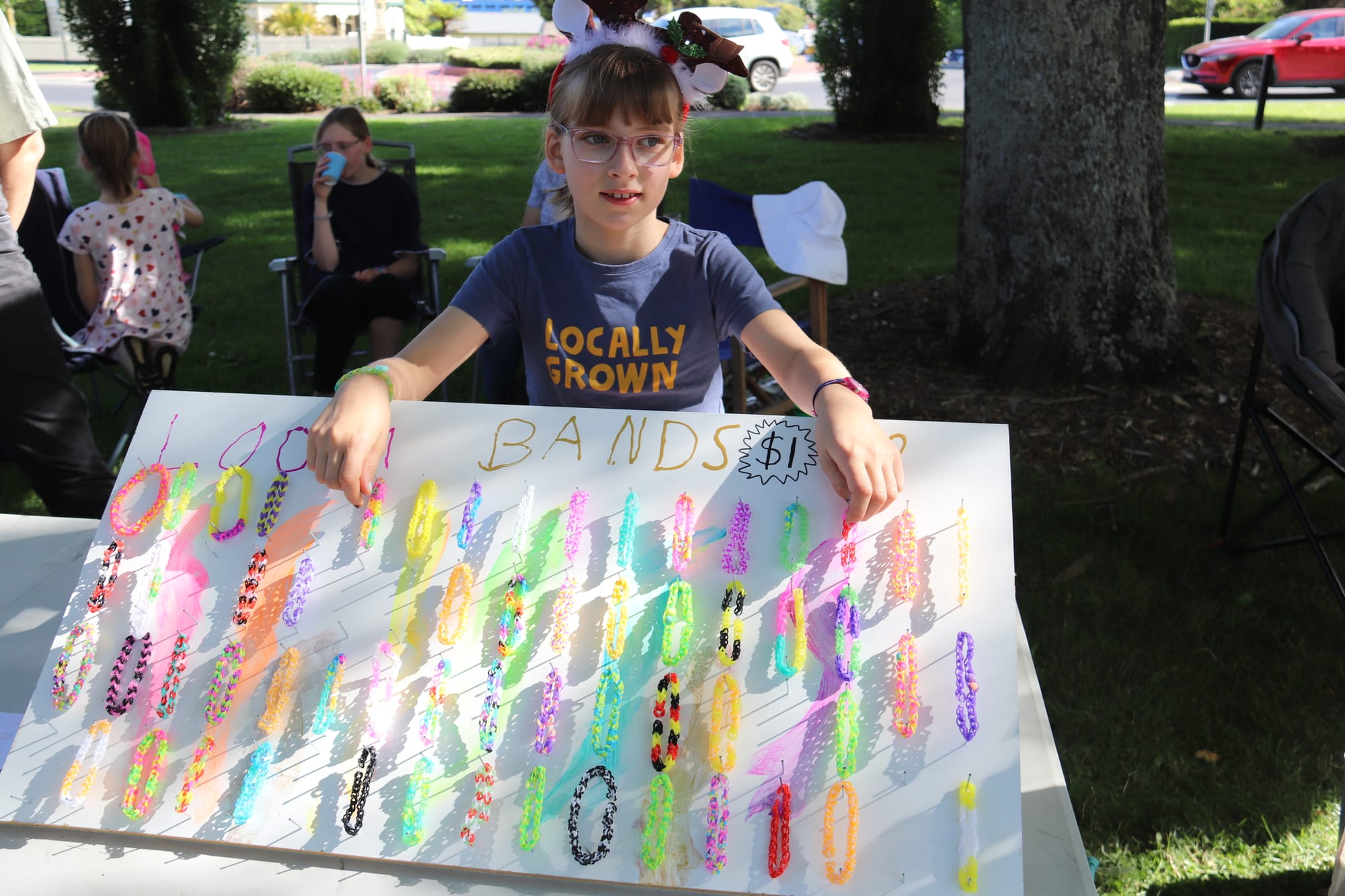 Charlotte Backman displays her collection of loom bands that she sold at the market.