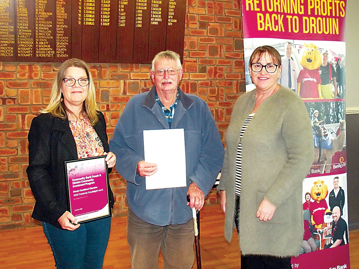 Drouin Combined Churches representatives Kylie Crawford (left) and Alan Lamond with community bank director Vanessa Marsh received financial support towards staging carols by candlelight.