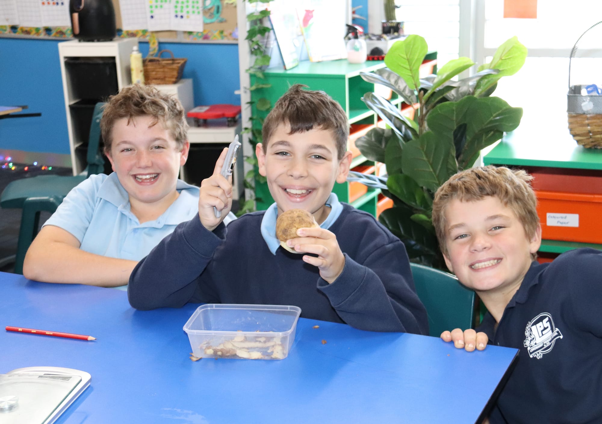 Tate, Hayden and Krue get to work peeling a potato.