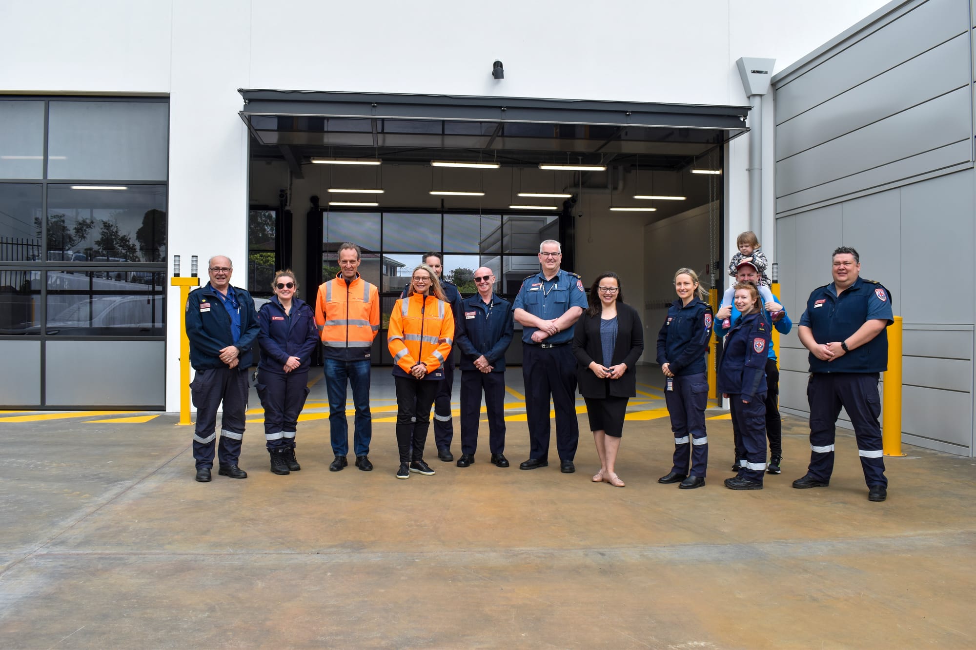 NOVEMBER: At the new Warragul West Ambulance Station are (from left) Ambulance Victoria Baw Baw senior team manager Ross Breaden, paramedic Sarah Findlay, May Constructions managing director Peter Ma and general manager Colleen May, paramedic Sean Gubbels, AV Gippsland regional support manager Eddie Wright, AV Gippsland area manager Paul James, Member for Eastern Victoria Harriet Shing, paramedics Teresa Santo, Eloise Thomas and Tim Haynes (with Berity Haynes on shoulders) and AV Gippsland regional director Ross Salathiel.