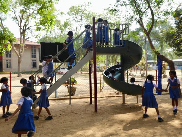 Sri Lankan youngsters delighted to be climbing and sliding on playground equipment 
