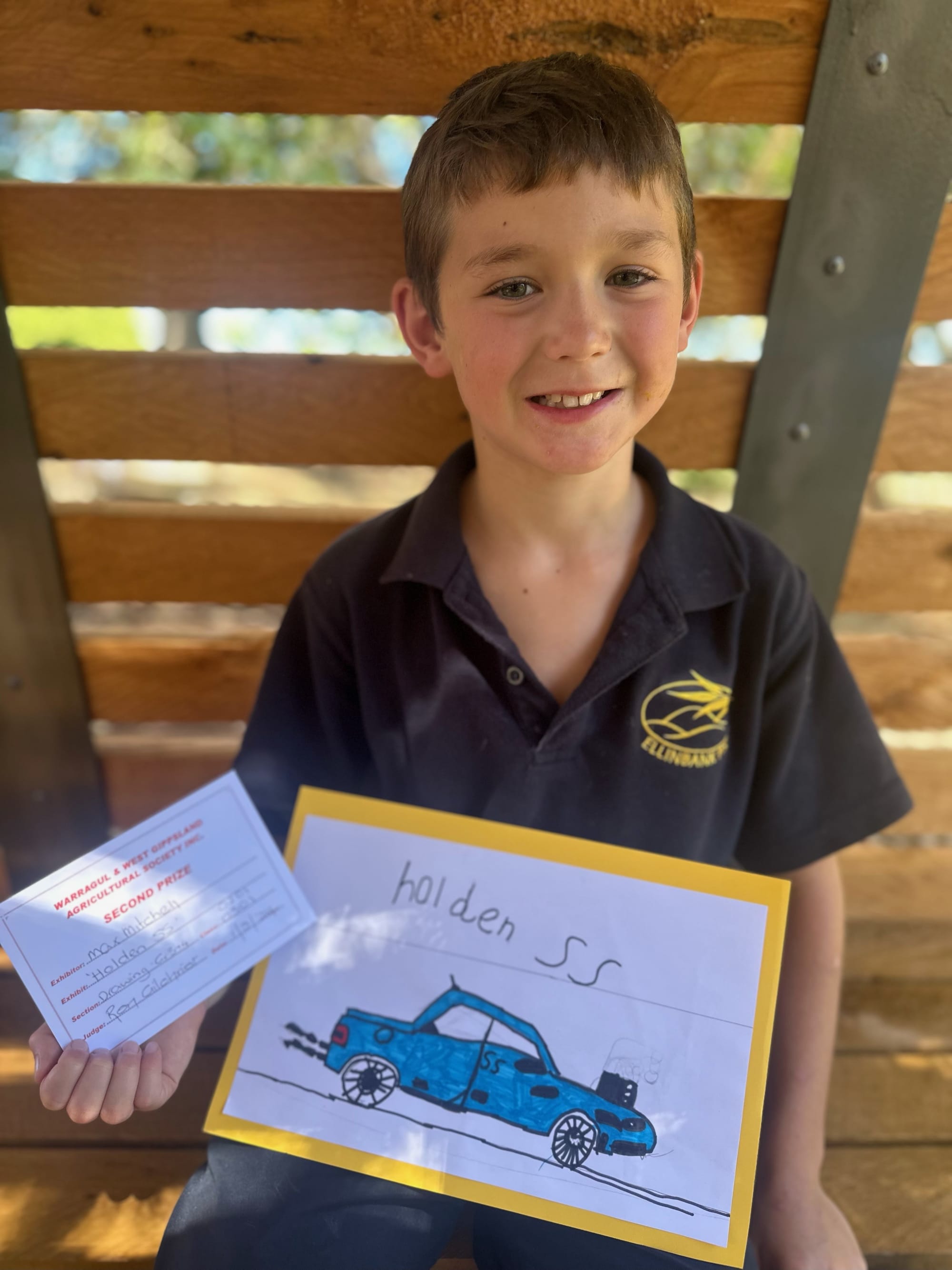 Grade three student Max Mitchell with his drawing which was awarded a second placing.