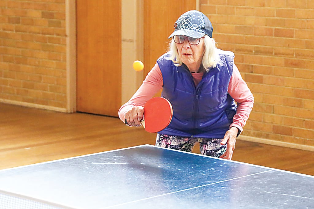 Jan Wishart keeps her eyes on the ball as she hits a backhand.