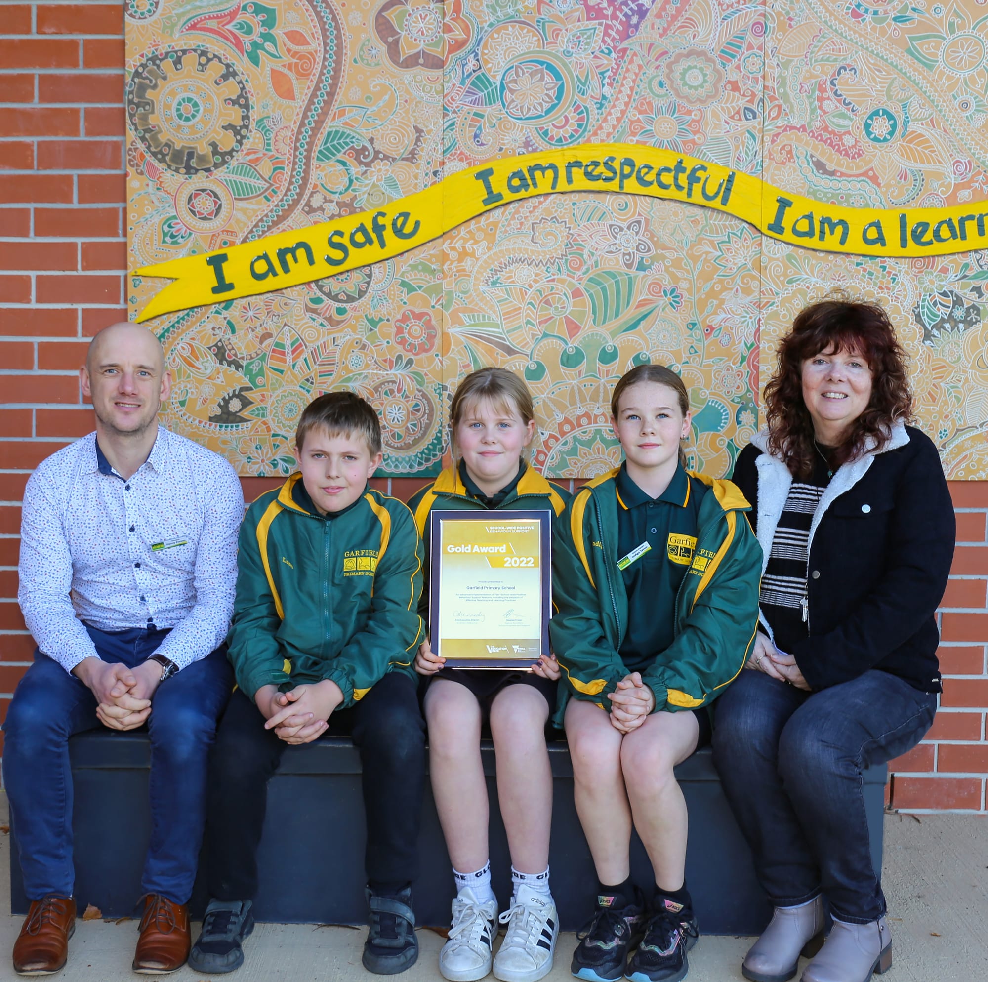 Posing with Garfield Primary School's new gold award are principal Danny Forster, school captain Lucas Hain, 'Aim for the Stars' leader Bella Grayham, school captain Indigo Taylor and teacher Jan Forward.