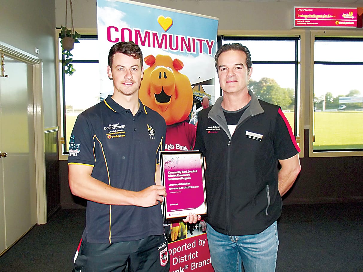 Longwarry Cricket Club's Dominic Pullen (left) accepts Drouin community bank sponsorship from vice-chair Matthew Williamson.