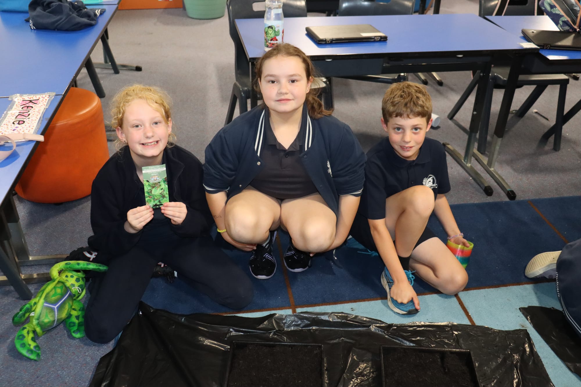 Working on their seedling plants are Year 3/4s, Summer, Emelia and Kyle
