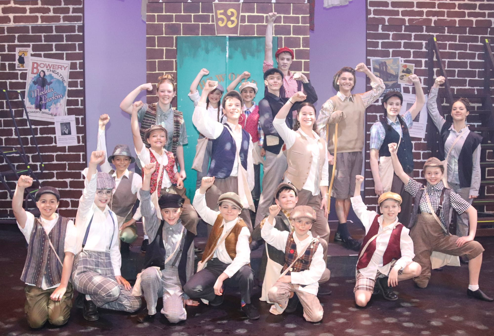 Fighting for their rights, the newsies get ready to seize the day. Back: Zali, Claudia, Marissa, Ethan, Noa, Lucas, Amelie, Paige. Middle: Annabelle, Josephine, Kaelen, Holly. Front: Poppy, Abigail, Adelaide, Emily, Mitchell, Jules, Xander, Aisha.