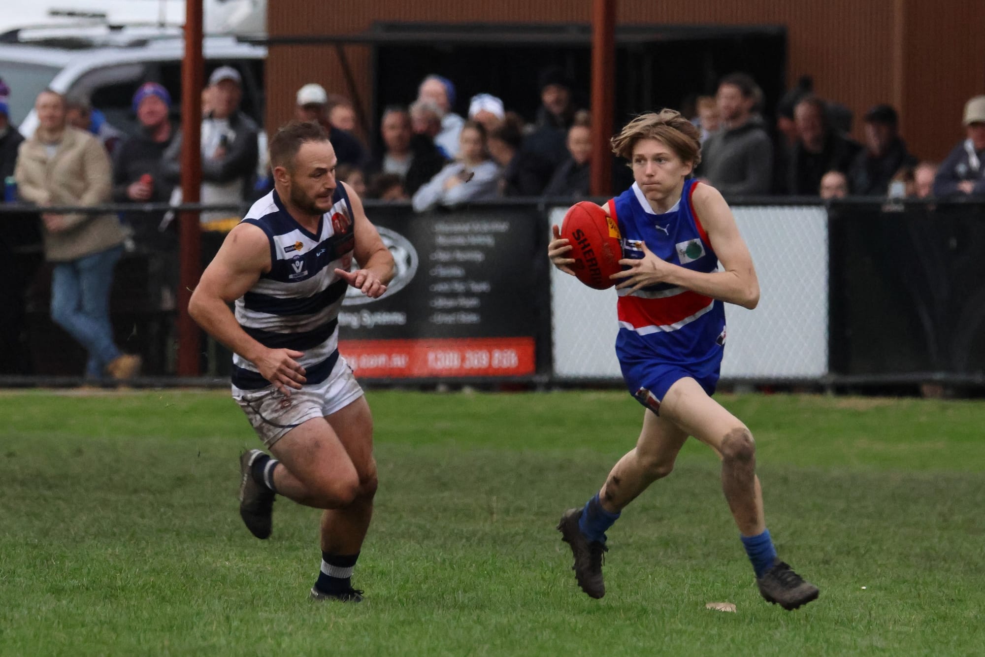 15-year-old Sam Hughes (right) breaks away from his Nar Nar Goon opponent in his first senior game. The Bulldogs' predicament has given young players like Hughes plenty of opportunities to get a taste of senior football.Photograph courtesy of NAR NAR GOON FOOTBALL CLUB.