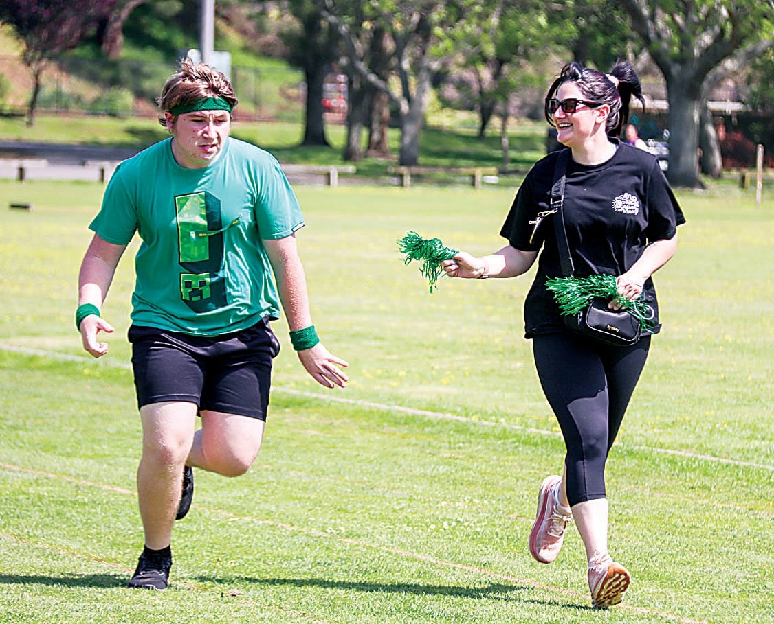 Kayden and mum Taylah speed down the athletics track.