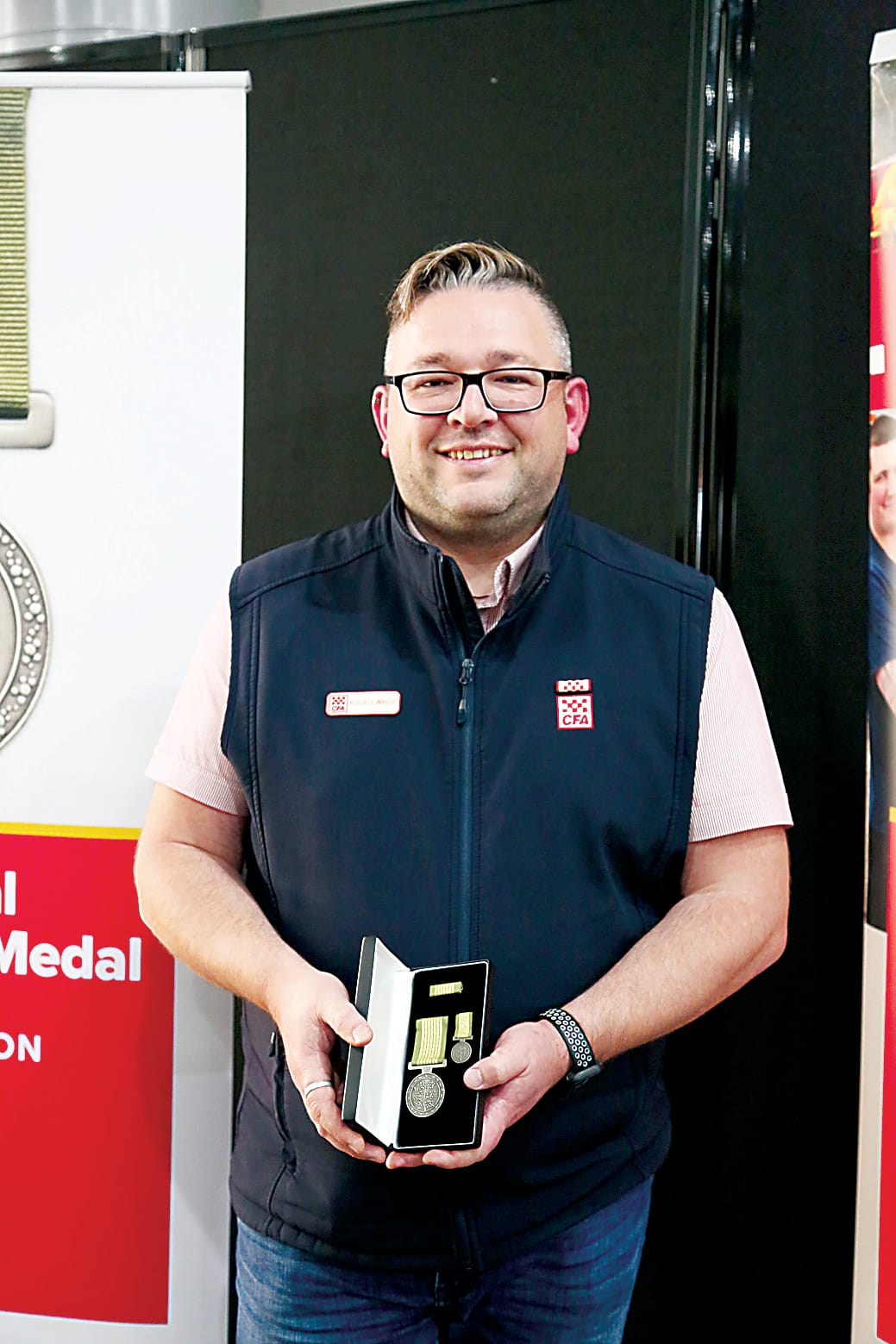 Erica and District captain Russell Wright with his National Emergency Medal.