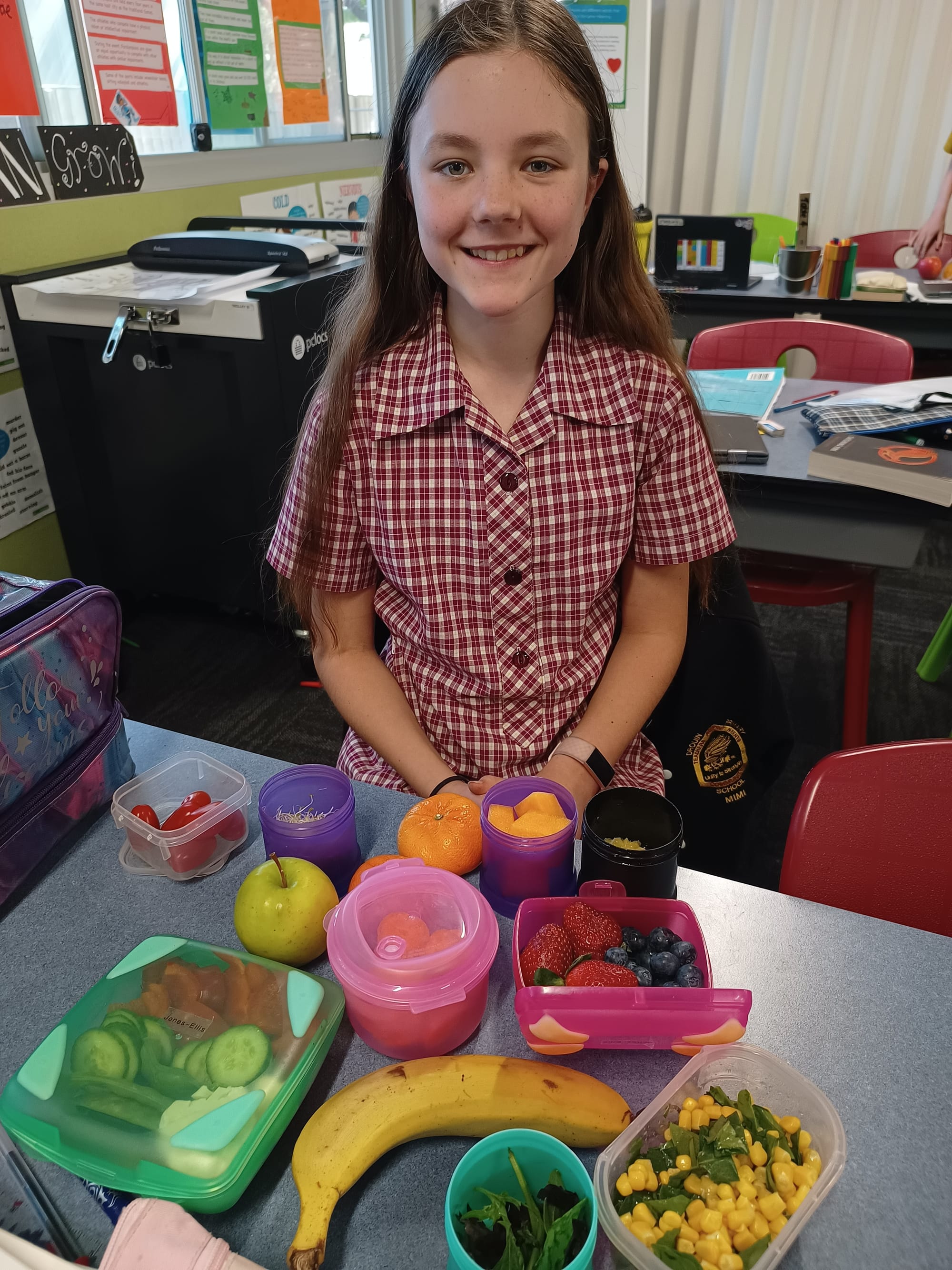 Grade six student Mia stacks her lunch box with healthy choices.