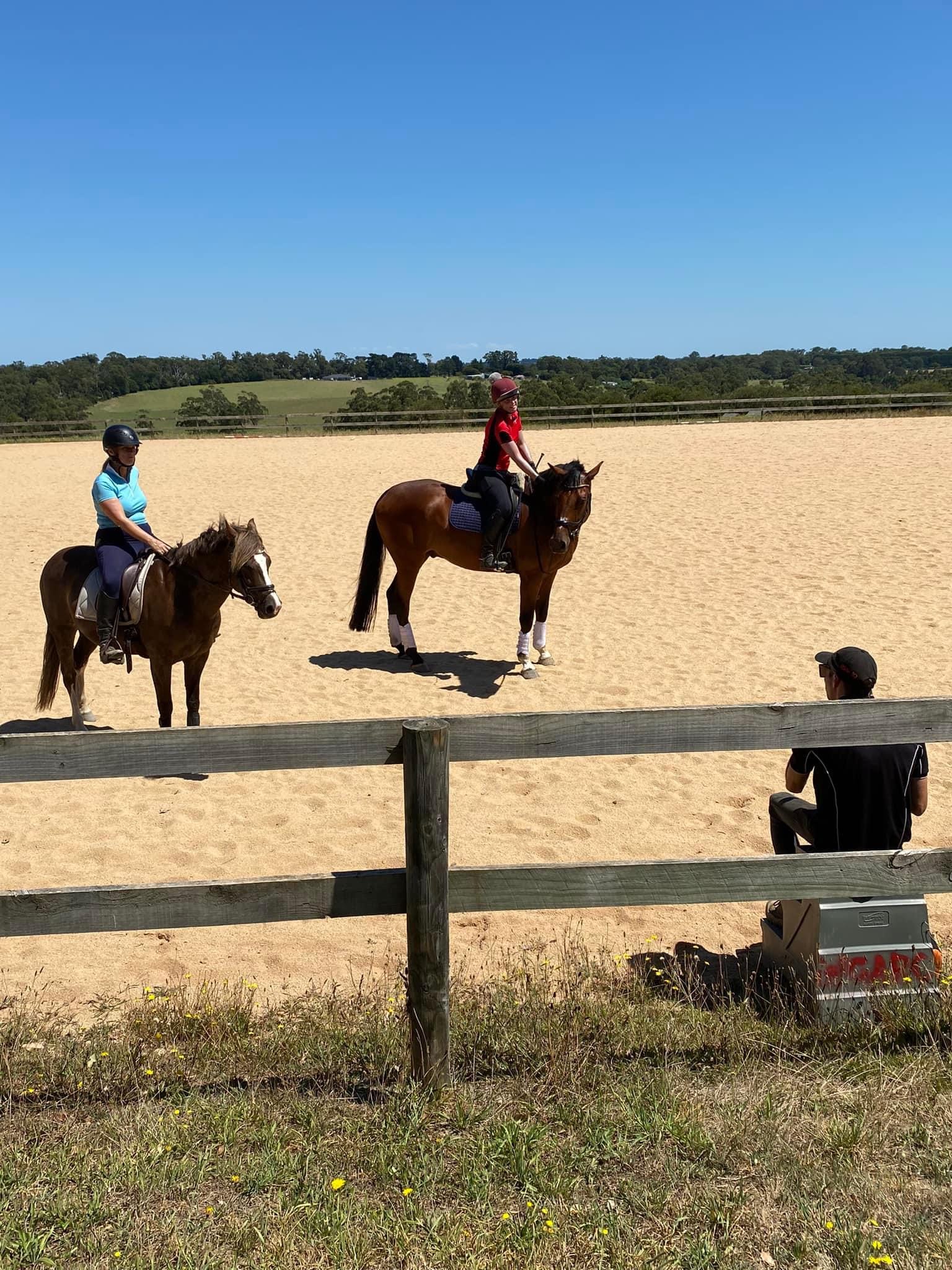 Local rider Abigail Hobbs and visitor from Loch, Robyn, receive instruction from coach Sam Jeffree during a session on the sand arena at the recent rally at Lardner Park.