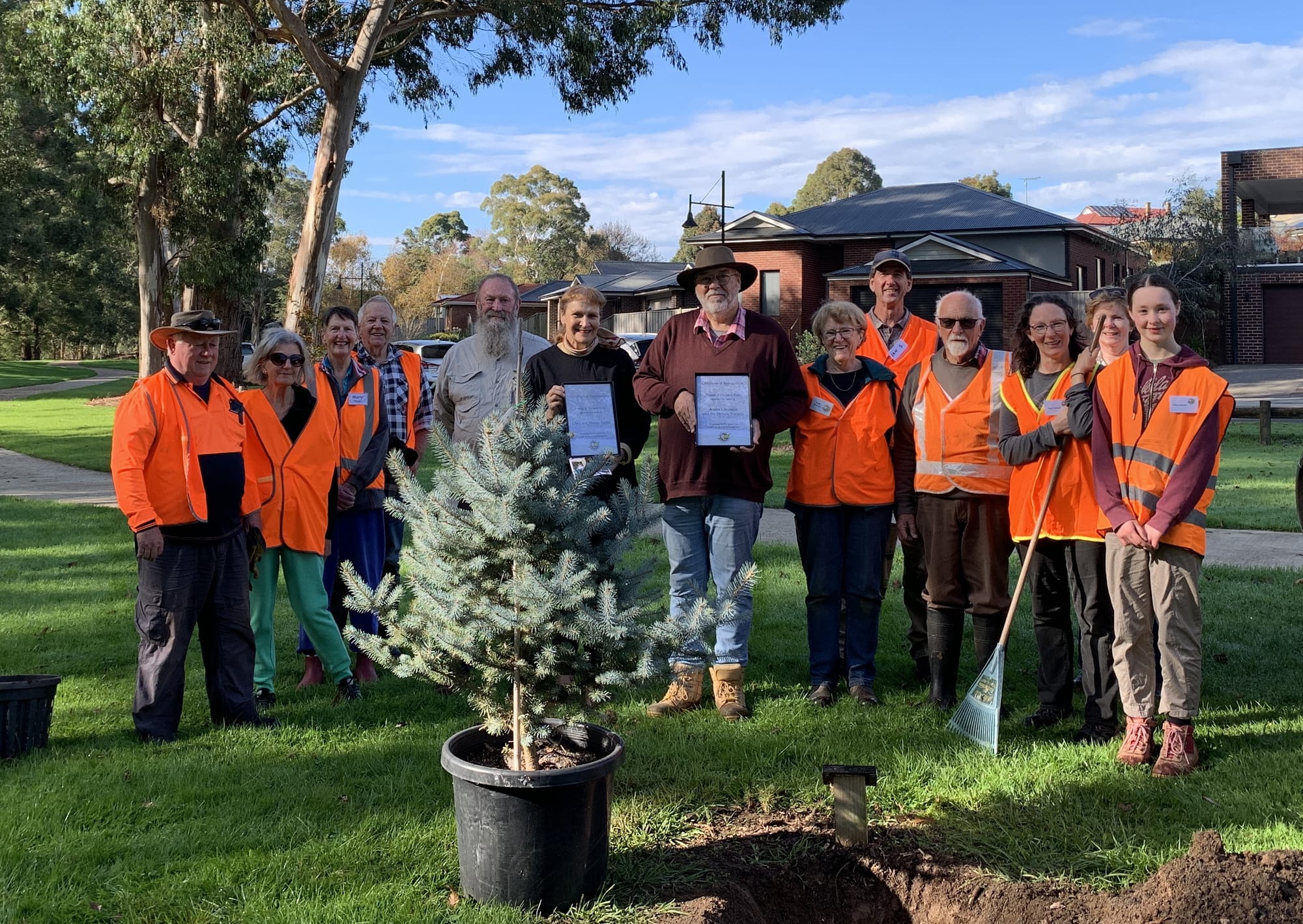 Gathered to celebrate a replacement Blue Spruce tree being planted at Alex Goudie Native Park are (from left) Henry Corcoran, Pauline Agius, Mary Gibson, Peter Ware, Chris Jordan, Sharon Jordan, Andre Linossier, Judy Farmer, Ian Swyer, Bill Boardman, Diane Haynes, Chris Celada and Libby Haynes.