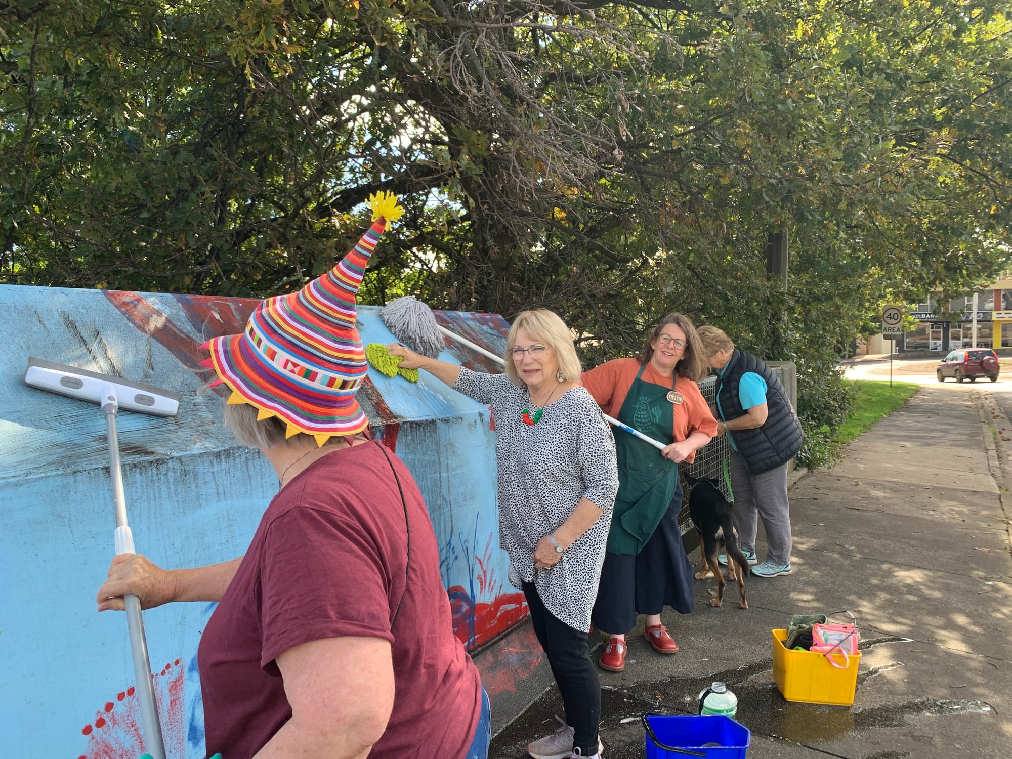 Scrubbing an artwork in Drouin are Rhona, Janet, Helen and Sue.