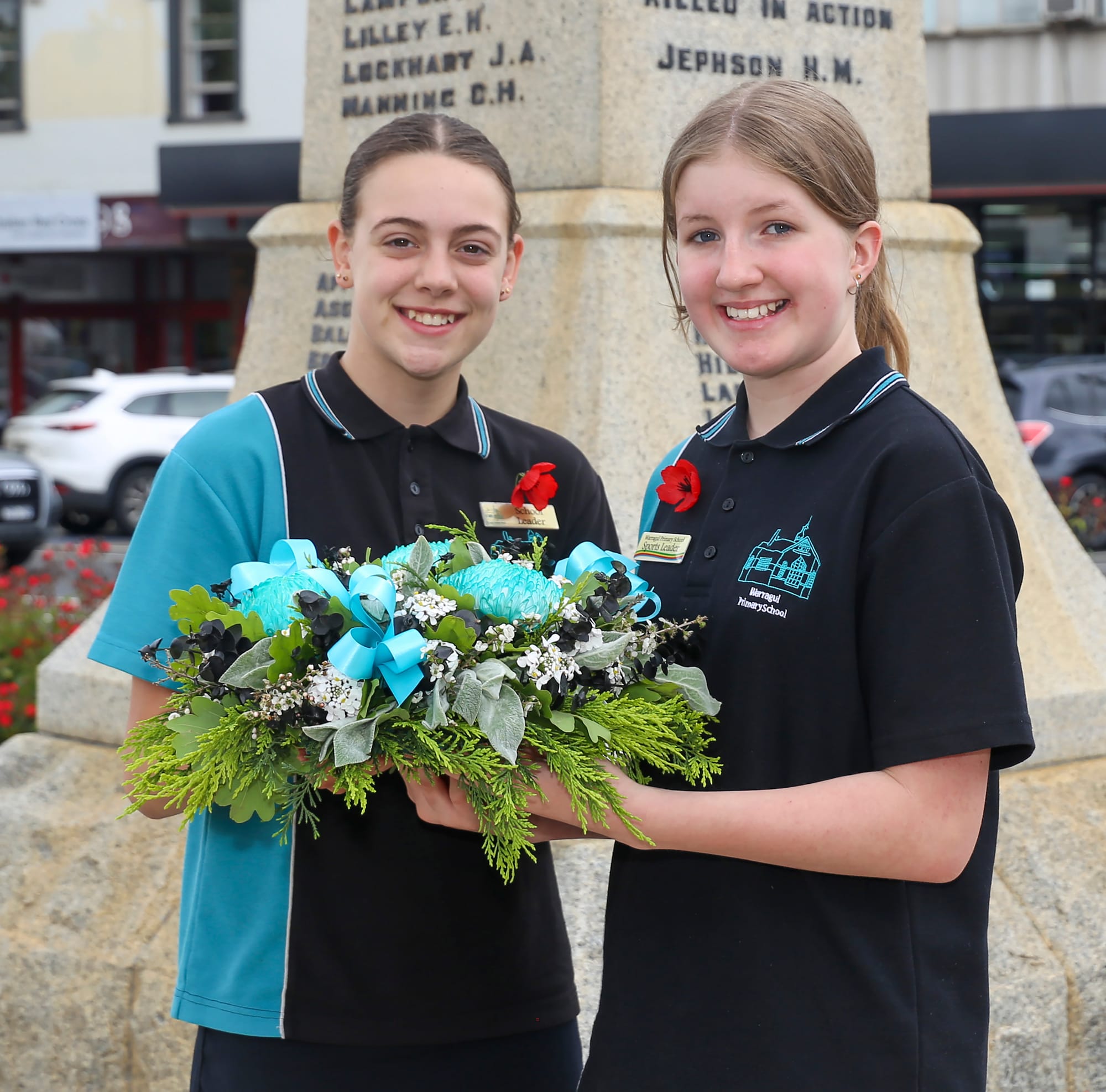 NOVEMBER: Warragul Primary School leaders Nakita Marriott (left) and Crystal Darwin hold a wreath at the Warragul cenotaph on Remembrance Day. Photograph: AMANDA EMARY.