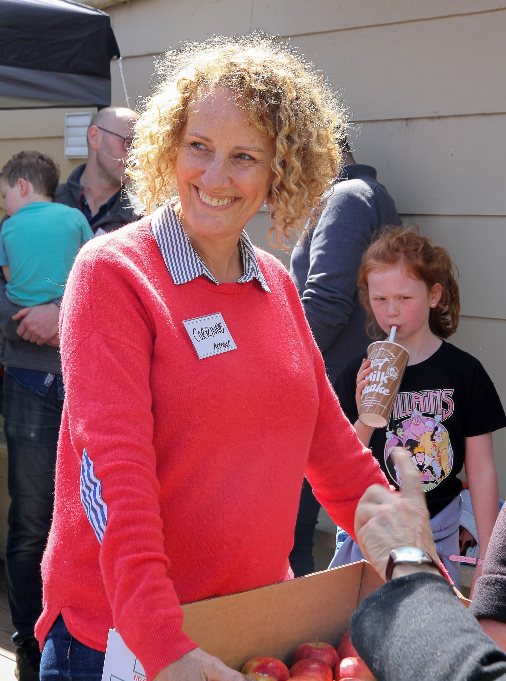 Corrinne Armour from Armour Apples hands out apples at the community day.