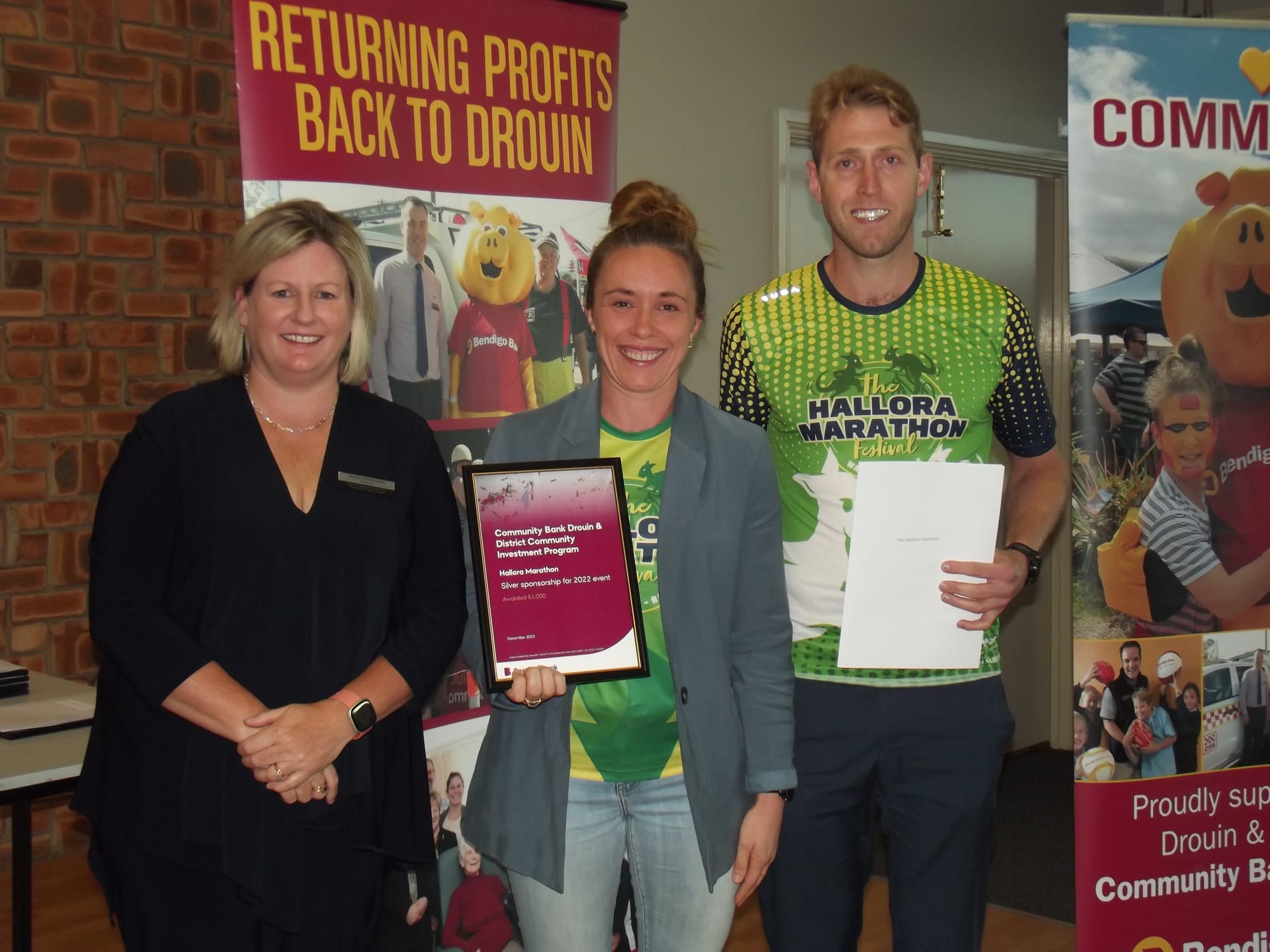Organisers of the Hallora Marathon run recently as a fund-raiser for the Peter McCallum Cancer Centre, Laura Coe and Daniel Pratt were presented with silver sponsorship towards the effort by Drouin community bank director Sonia Lombardo.
