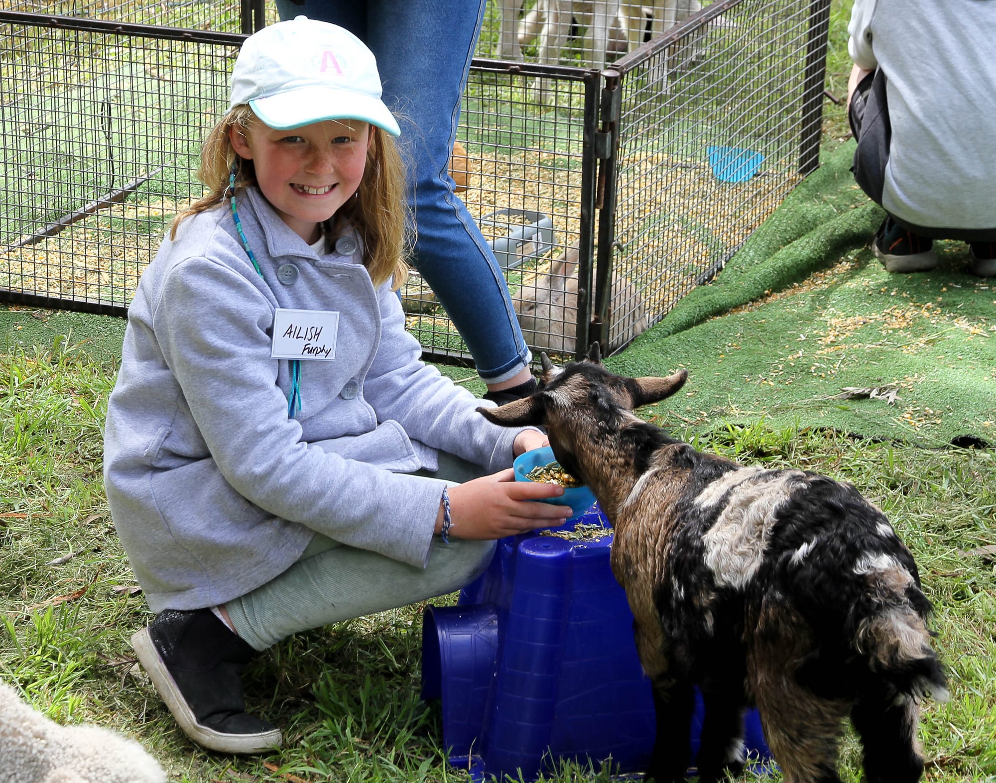 Local Ailish Furphy is loving feeding the kid goat.