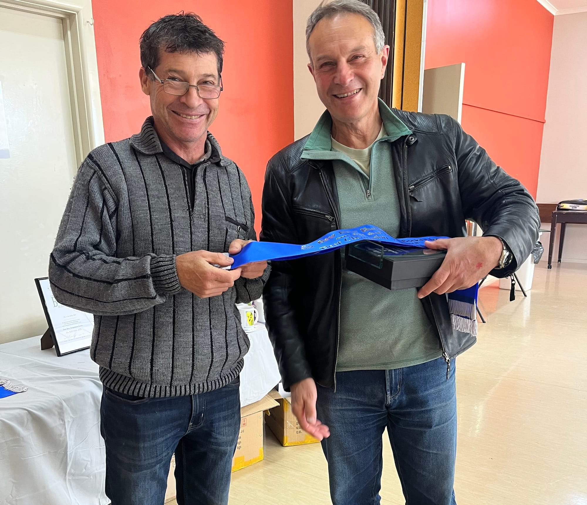 John Rowe with Martin Paoli receiving his trophy and sash for best adult bird in show.