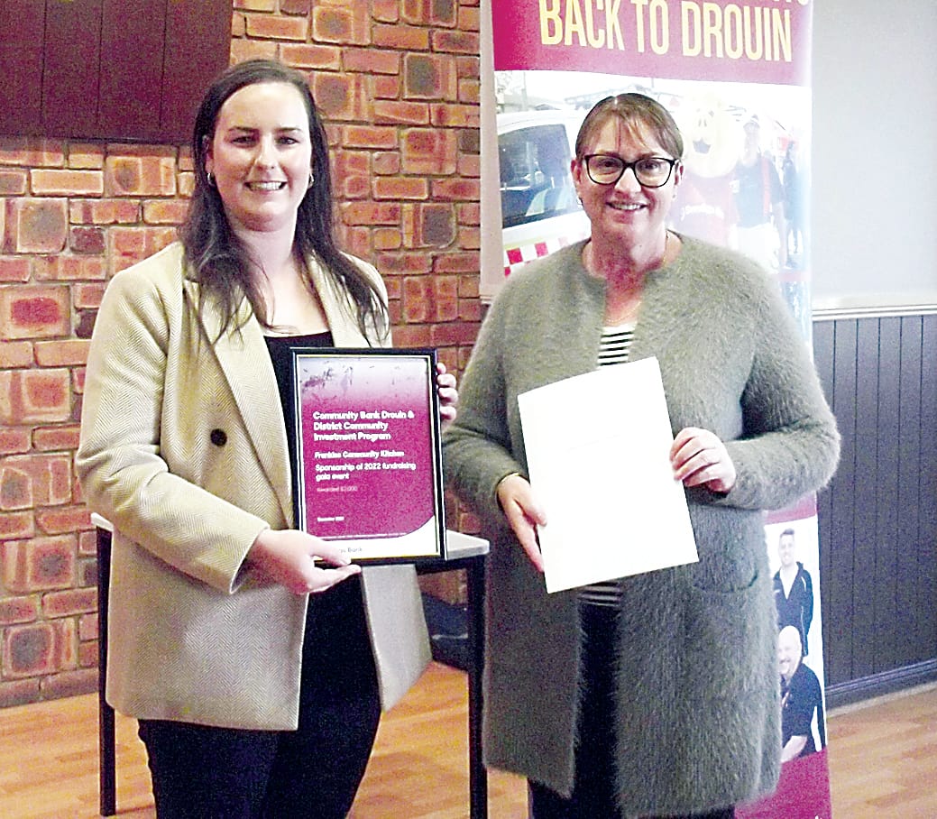 Frankie Mason (left) from Frankies Community Kitchen at Warragul receives financial support from bank director Vanessa Marsh.