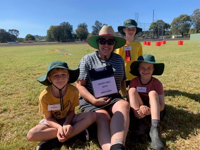 Waiting patiently between events at the athletics carnival are Tom, Elsa, Samuel and Bobby (back).