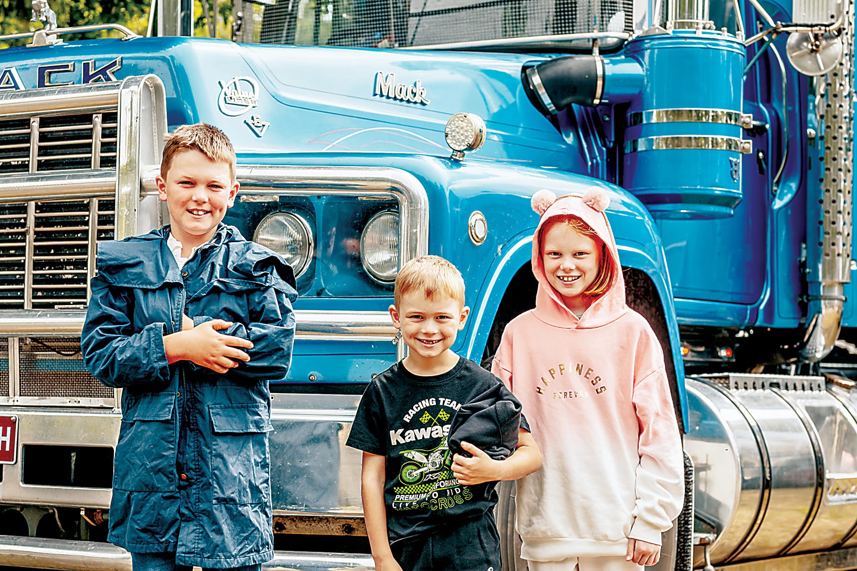 Drouin South's Dylan, Travis and Evie Marshall  check out some trucks.