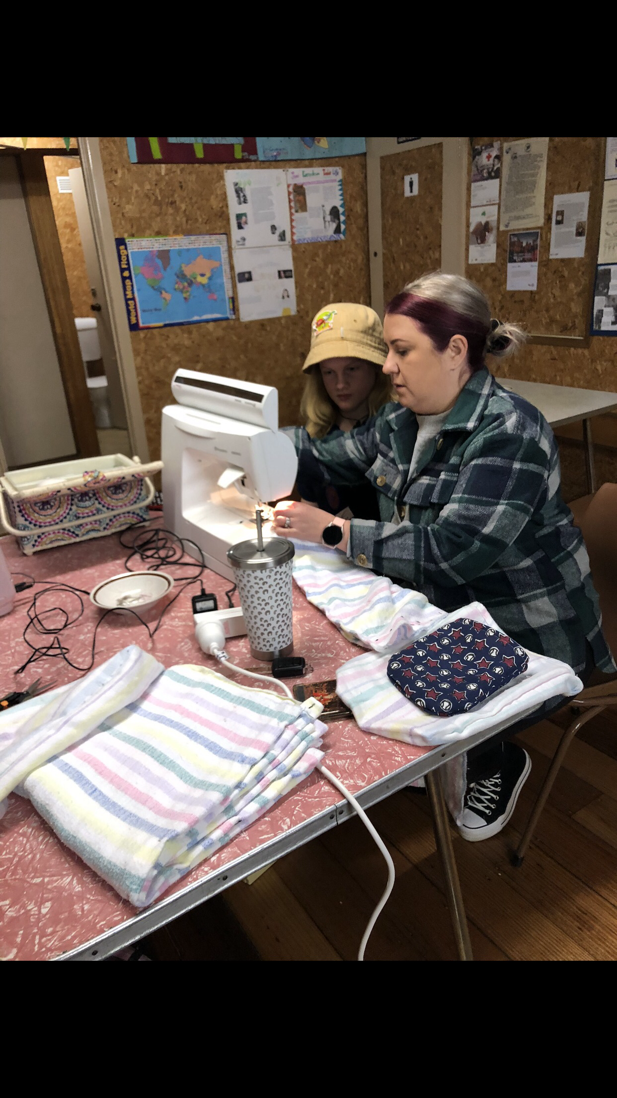 Parent Ashlee Slaughter assists Drouin Girl Guide member Lauren Burge to sew an animal pouch for wildlife.