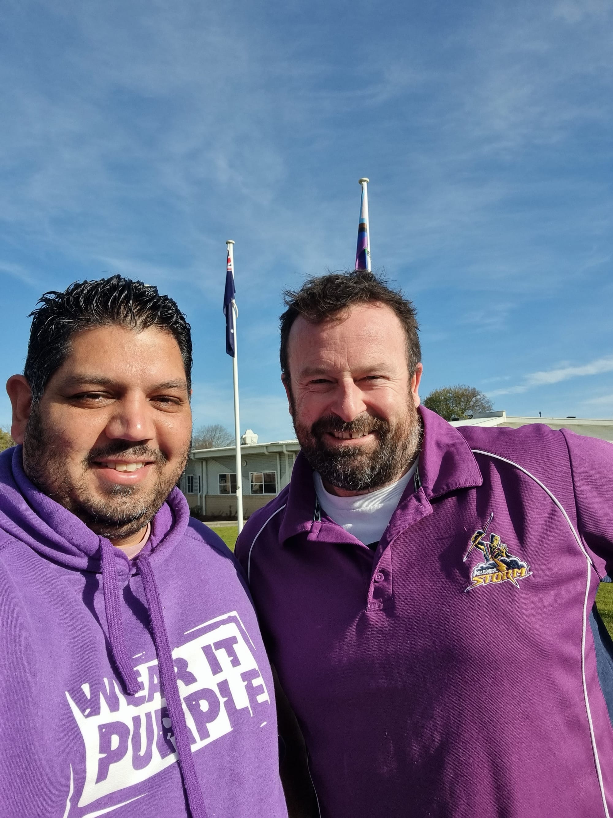 Student welfare manager Wombat Lyons and principal Brett Pedlow show their support by wearing purple.
