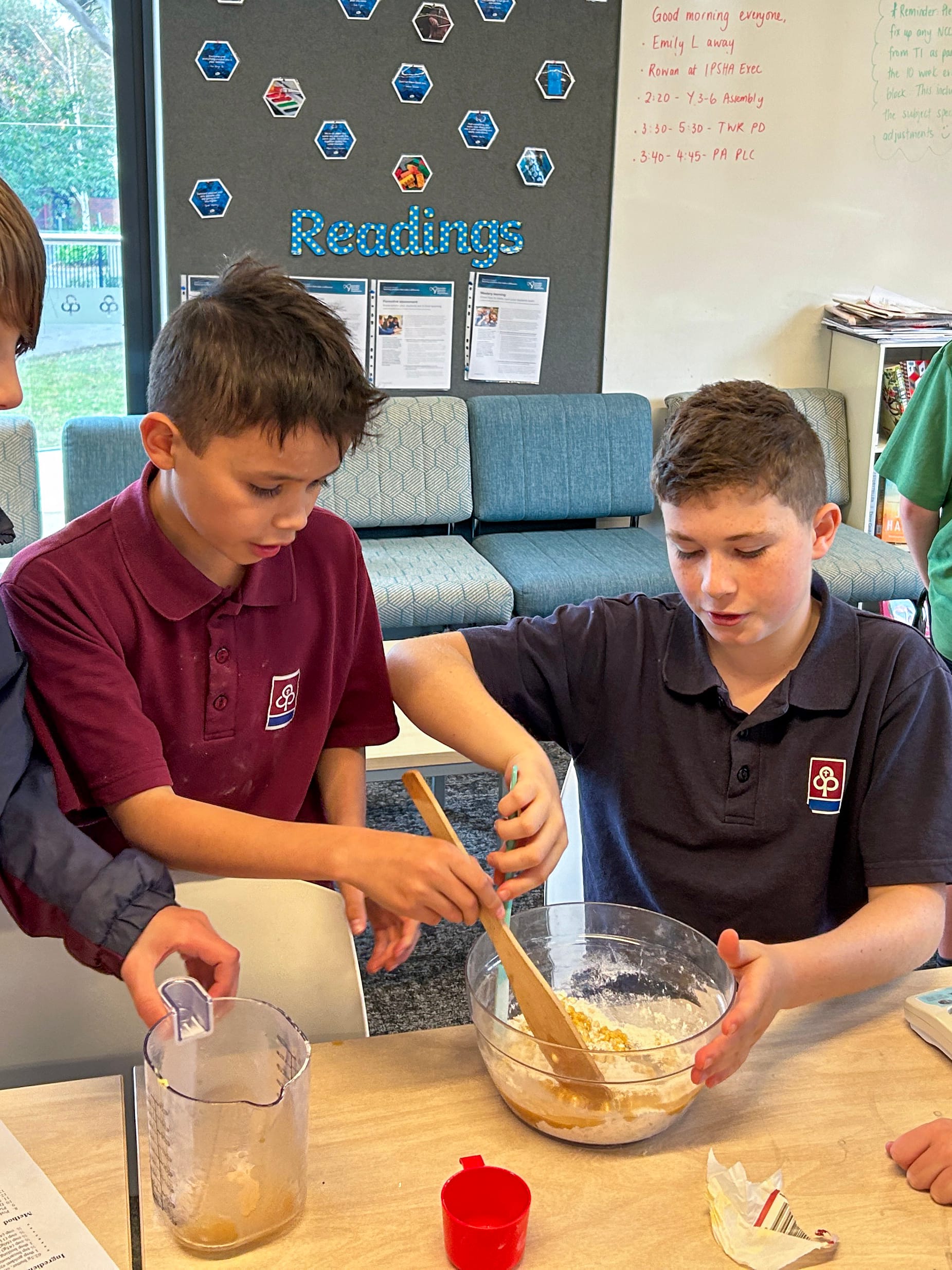 Teamwork with Rex Lockett and Lucas Keeble stirring the ANZAC biscuit mixture together.
