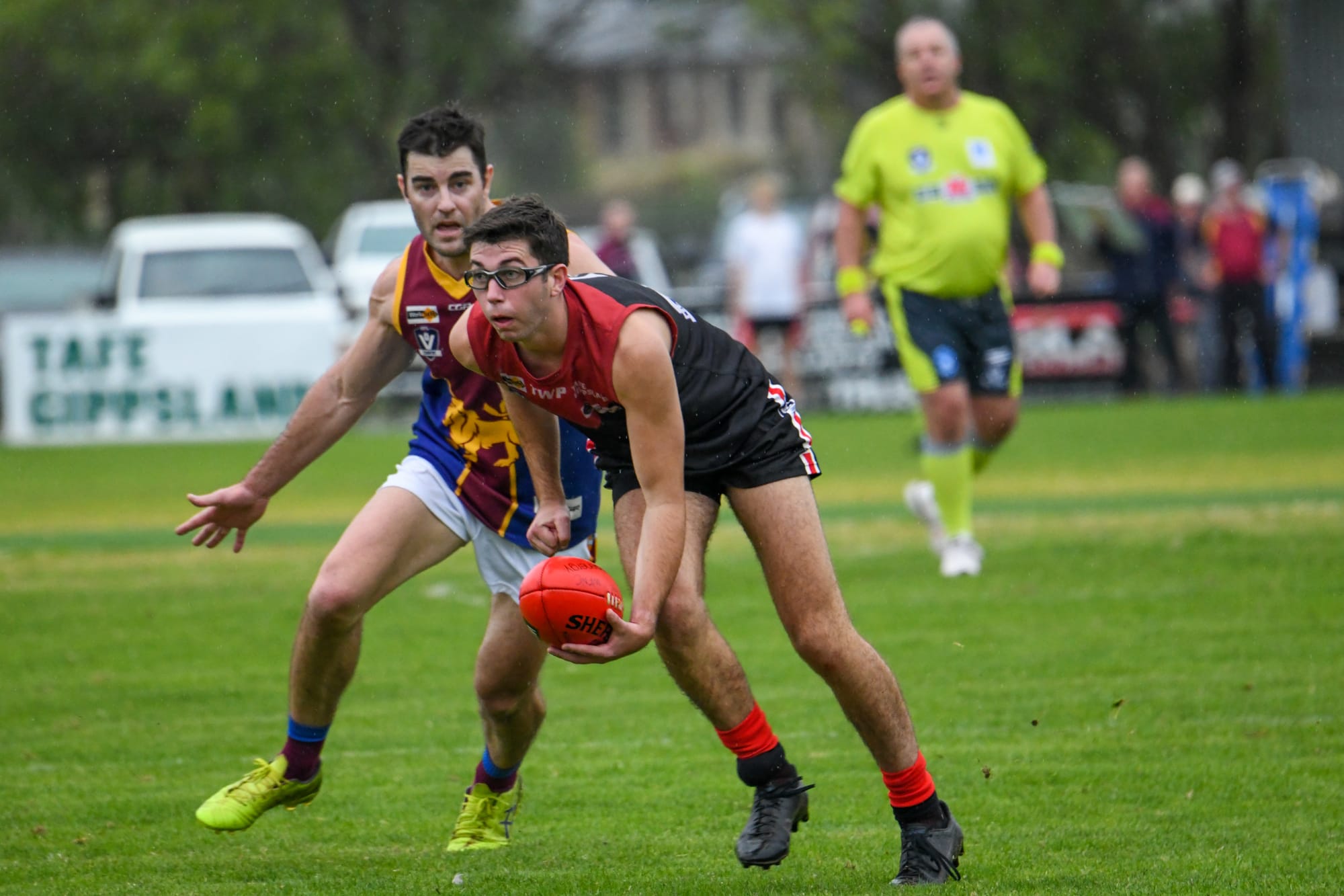 Cooper gets a handball away playing for Warragul during the season. The goggles he wore throughout the year are the same kind that Collingwood's Mason Cox wears.