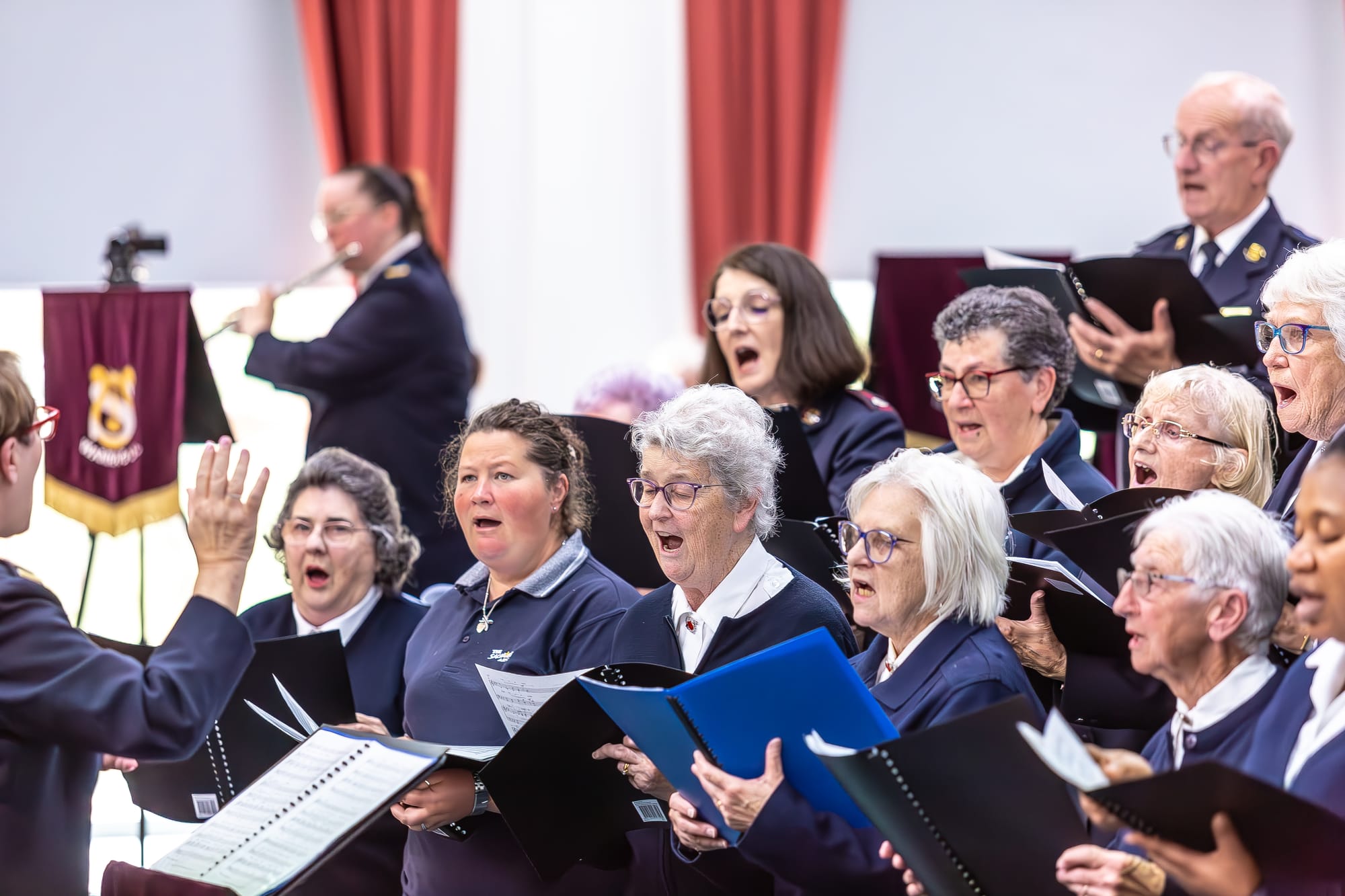 Salvation Army Warragul Songster Brigade Pauline Still (Songster leader) with (front) Margaret Paulin, Bec Stewart, Meg Edwards, Brenda Morris, Irene McNab, Blessing Maduka, (centre) Major Kirsten Elliott, Sue Bond, Major Shiena Davies, Marjorie Clement, (back) Russell Zelle, Flute: Danielle Green.