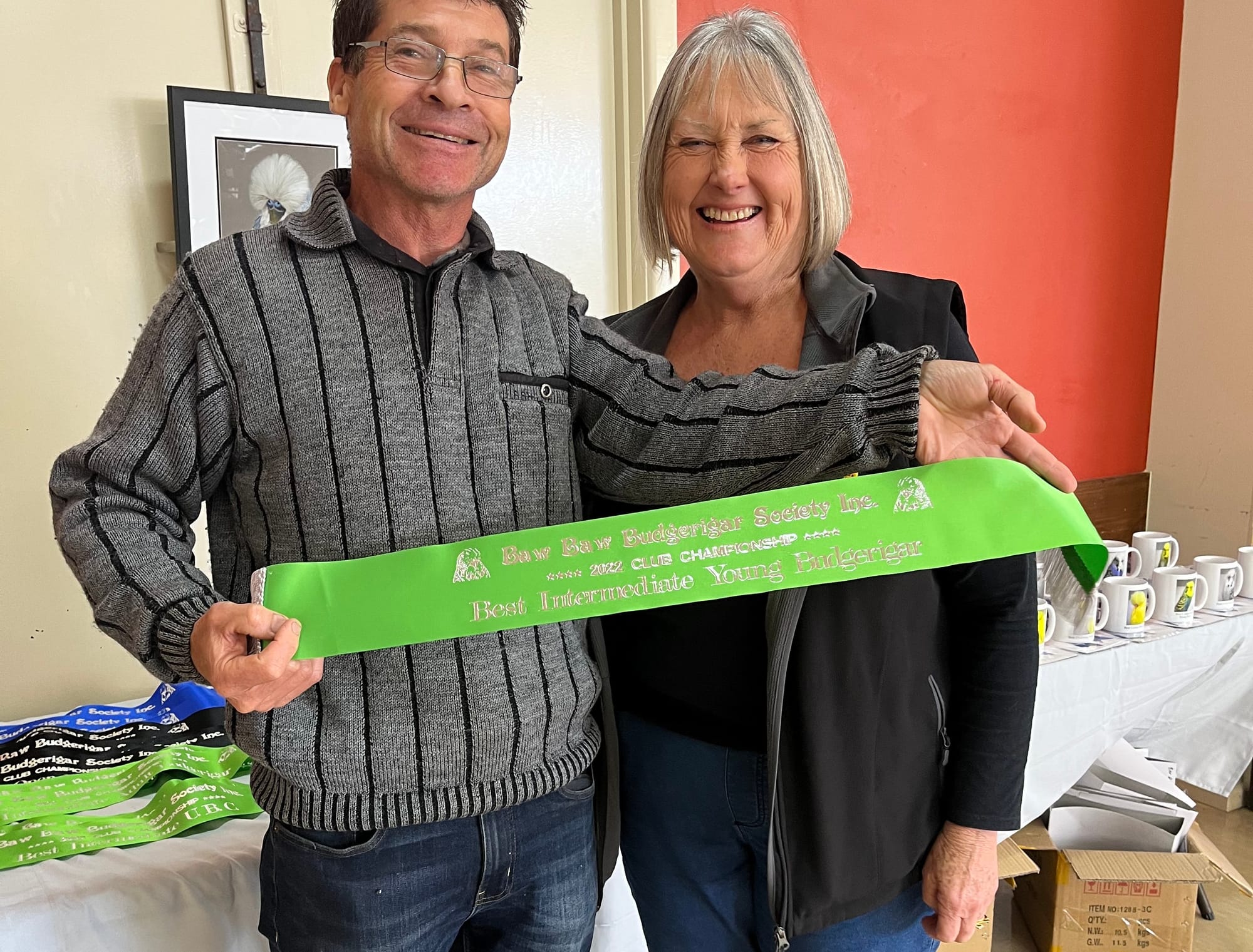 John Rowe with Maxine Clarke receiving her sash for best intermediate young bird in show.
