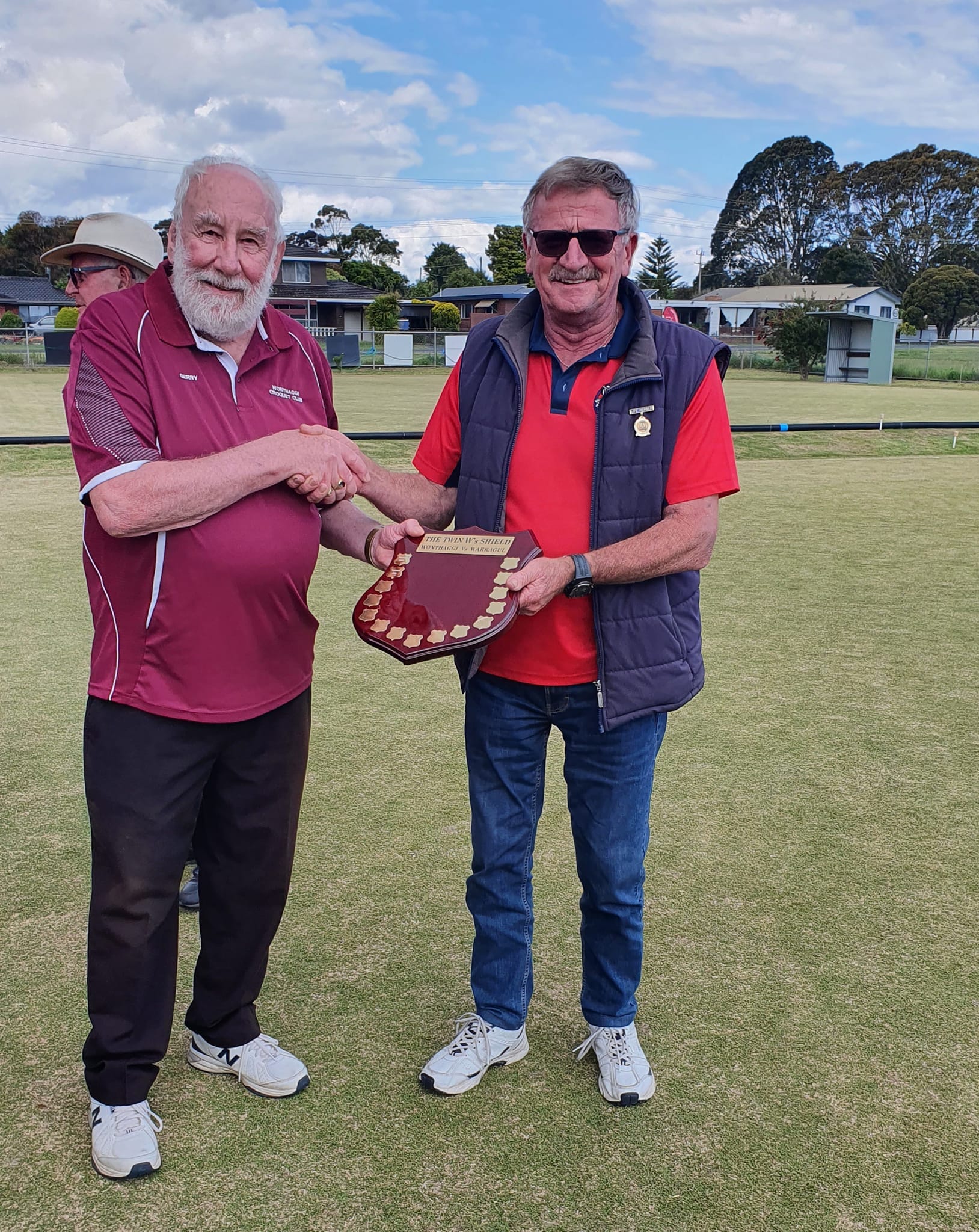 Warragul VP Russell Marriott handing over the Shield to Wonthaggi President Gerry Kool at end of day