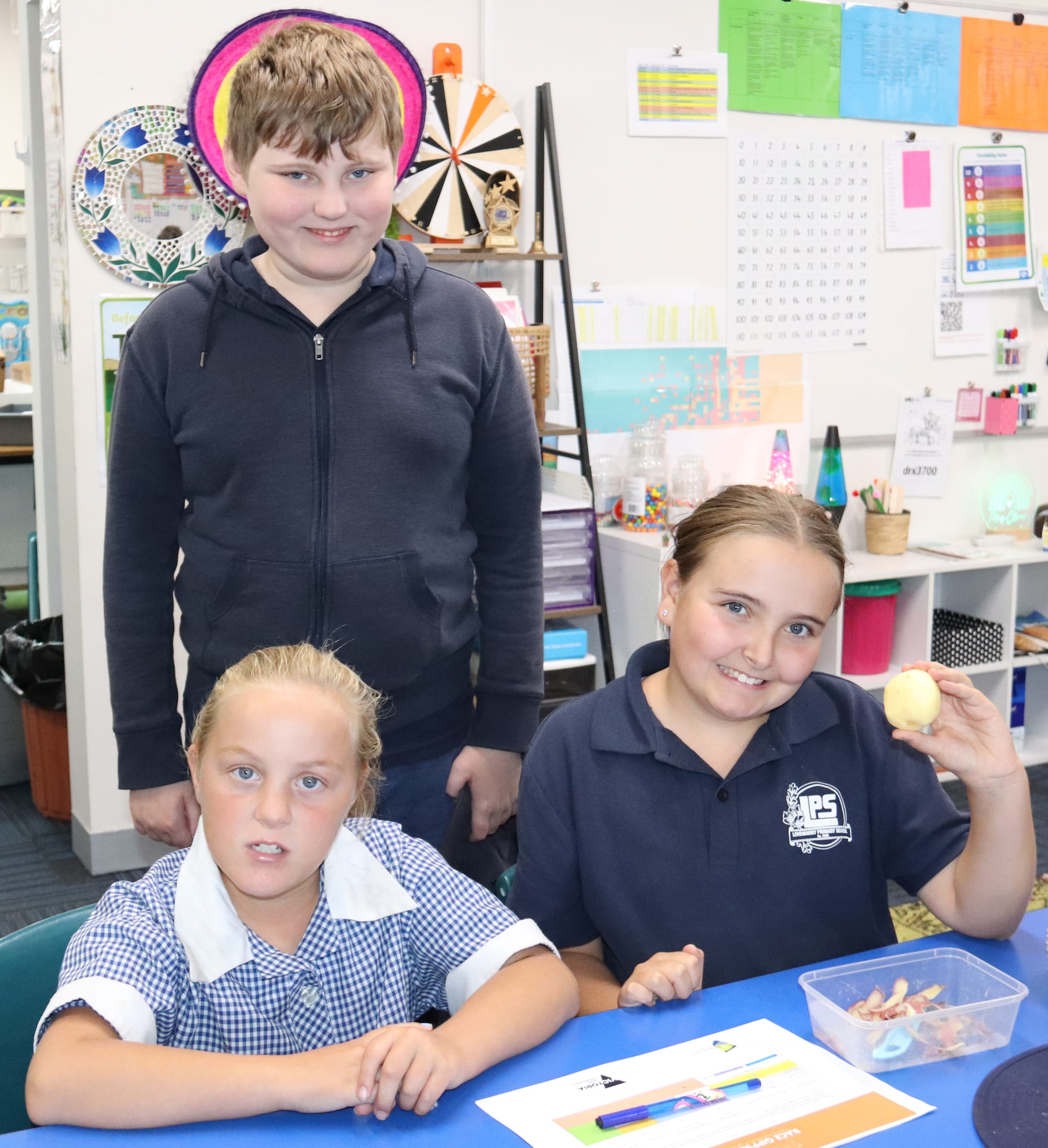 Chase (behind), Brooke and Alivia show off their peeled potato.