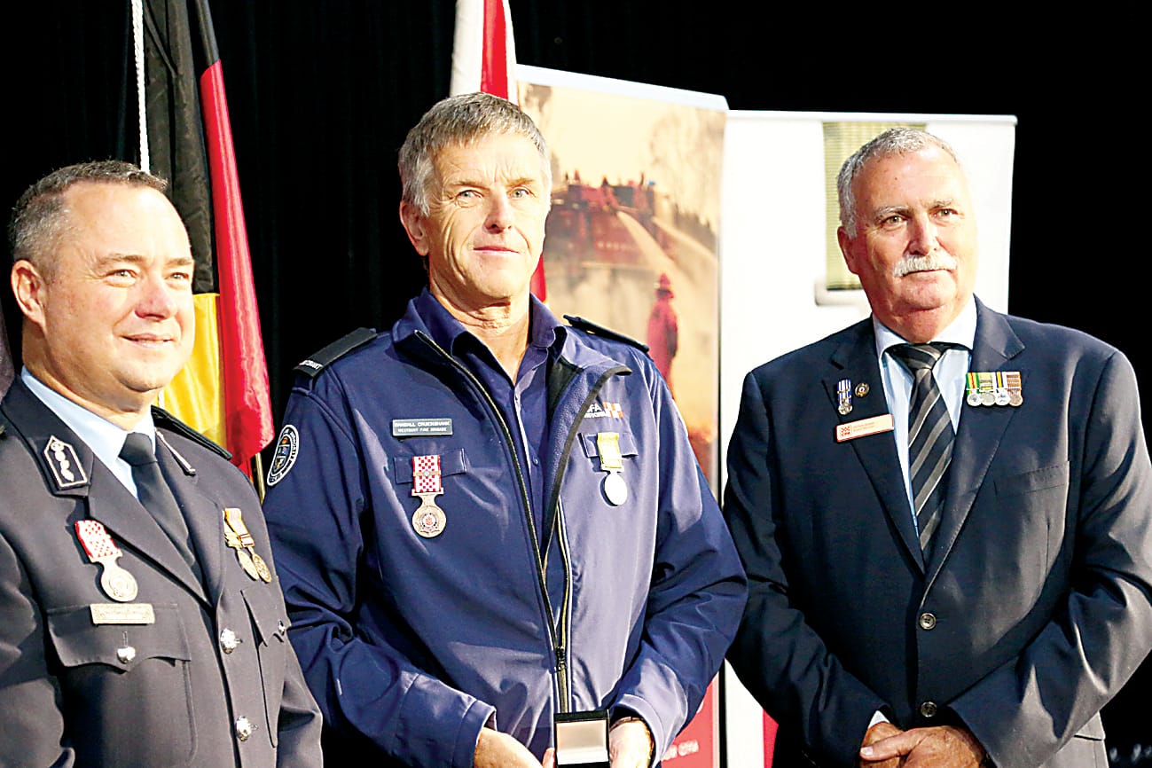 Westbury member Randall Cruickshank is presented with his medal by deputy chief officer Trevor Owen (left) and CFA board member Peter Shaw (right).