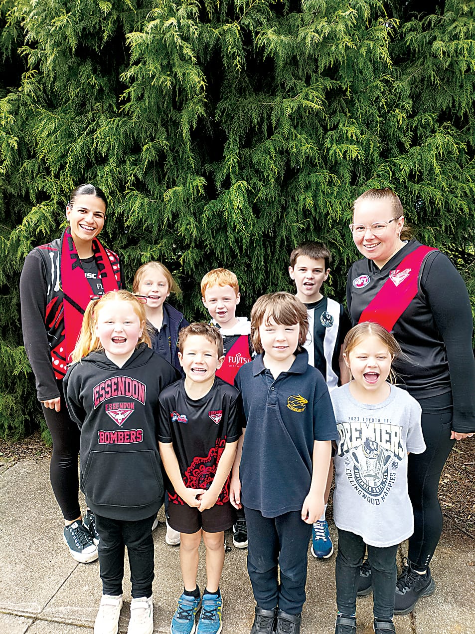 Right: The Ellinbank Primary School prep to grade two class show off their favourite team colours. they are (back, from left) Bree Monacella (education support), Grace Janssen, Angus Hodgson,Tate Oldham, teacher Emma Grigg, (front, from left) Olivia McPherson,  Flynn Mitchell, Jack Foley and Madi Ashby.