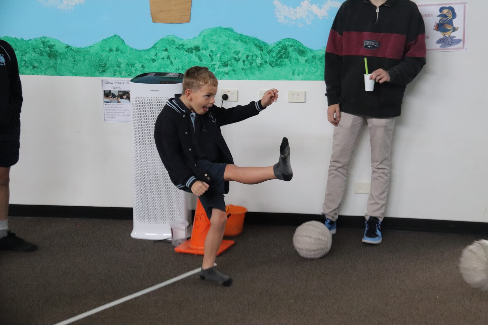 Dylan enjoys booting a ball at the big inflatable target.