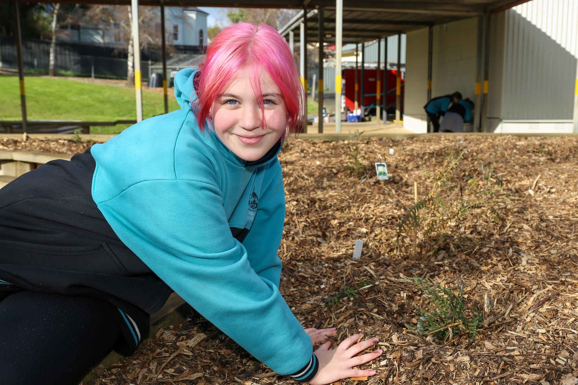 Maya Christensen is all smiles as she interacts with the bush food garden.