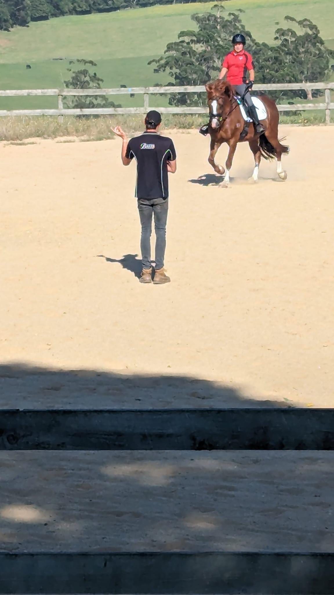 Coach Sam Jeffree takes West Gippsland Adult Riding Club member Vicki Bull from Buln Buln East through dressage techniques on the sand arena.