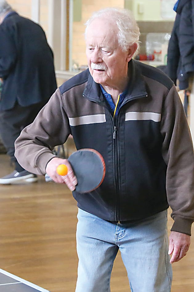 Making contact on a return is Clive Ayerst.