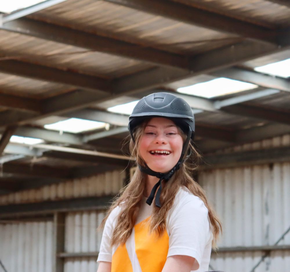 Volunteers helping riders interact with horses post image