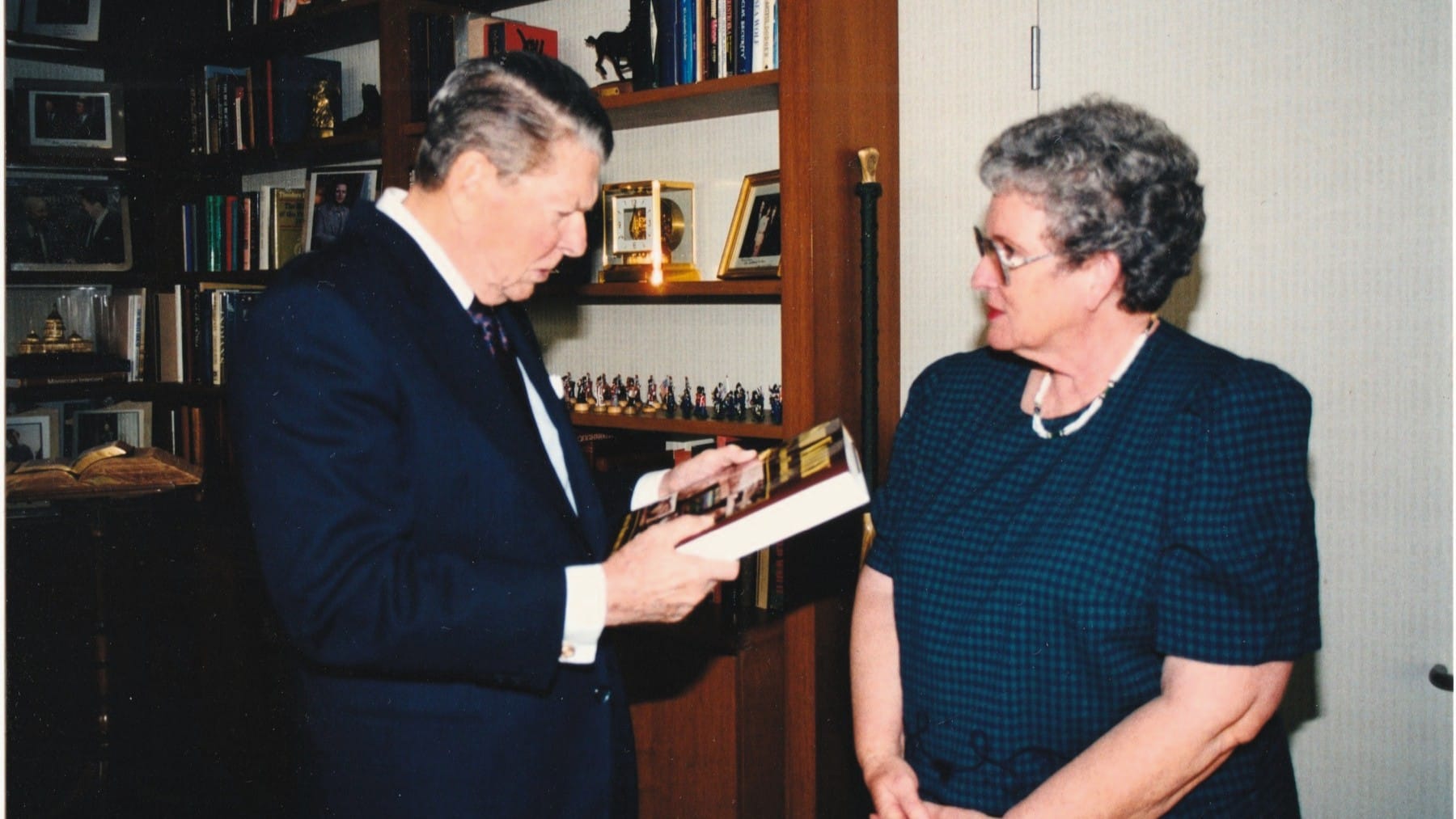 Image Credit: Russ Havens - Pat Havens looks on as President Ronald Reagan holds a copy of her book