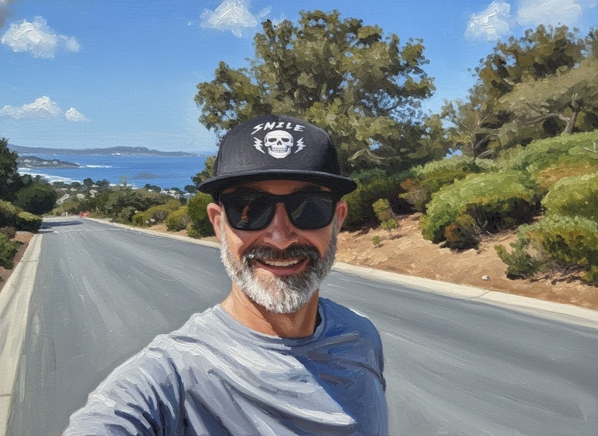 Jason smiling on a sunny coastal road above the bay