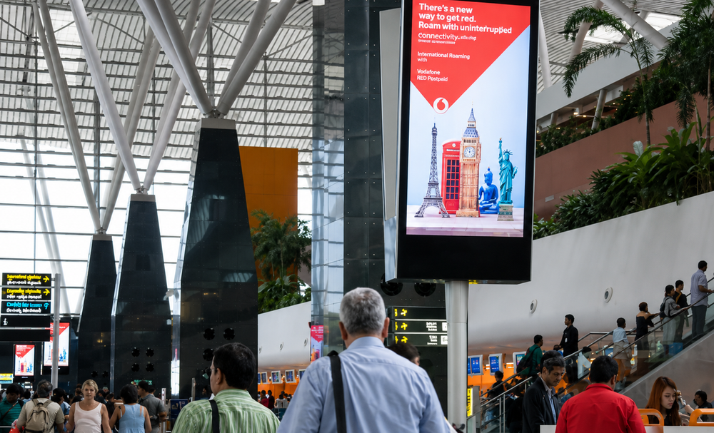 Digital advertising placement mockup at Kempegowda International Airport (BLR), Bengaluru, reaching Diwali 2026 festive travellers.