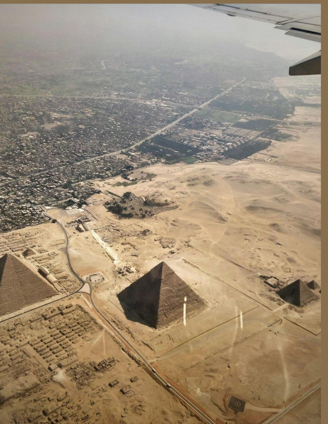 Aerial view of the Pyramids of Giza from an airplane window, Cairo, Egypt