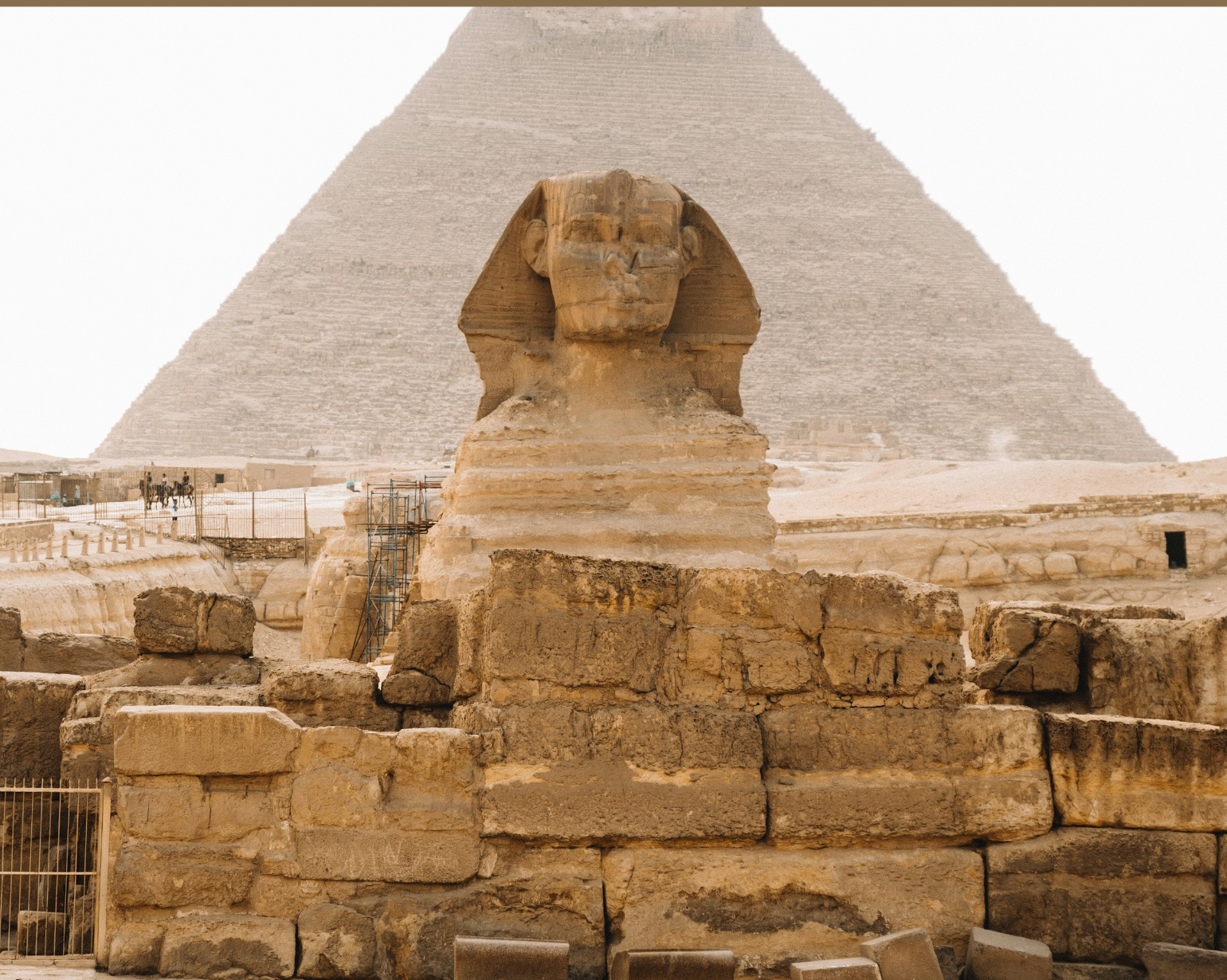 The Great Sphinx of Giza with a pyramid behind it, Giza, Egypt