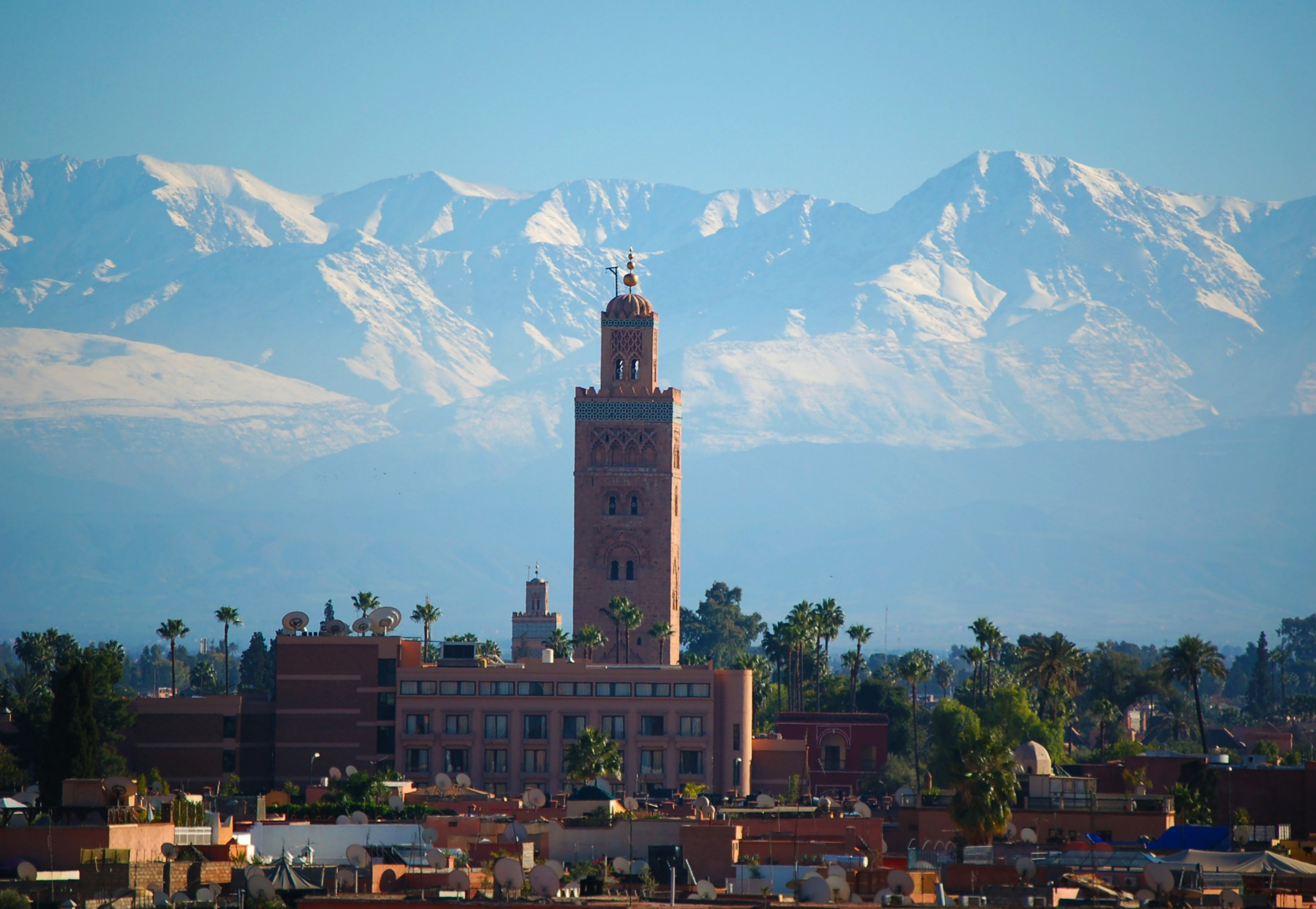 Koutoubia Mosque minaret with the snow-capped Atlas Mountains behind Marrakech, Morocco