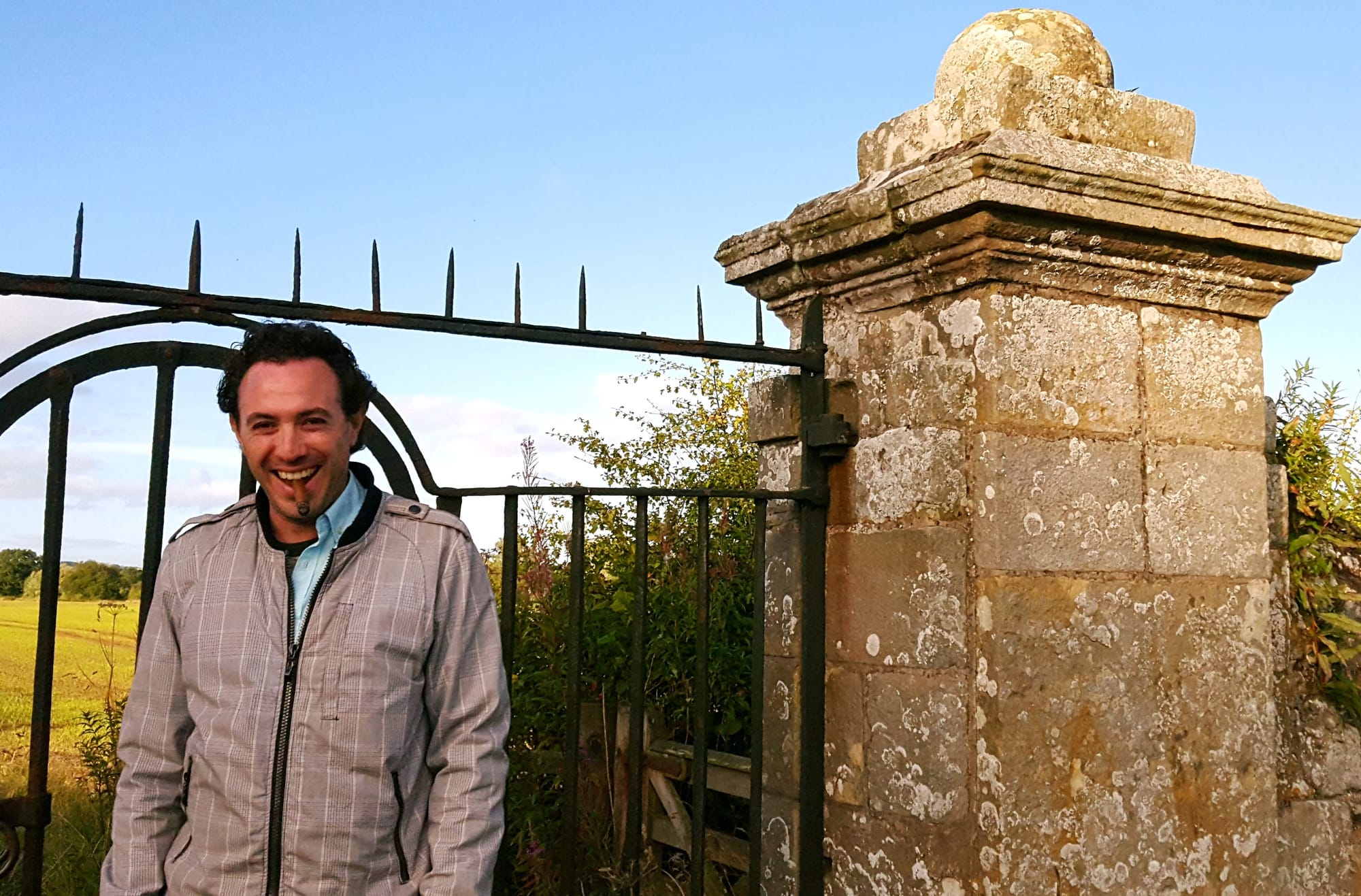 Photo of André Baca-Acosta smoking a cigar.