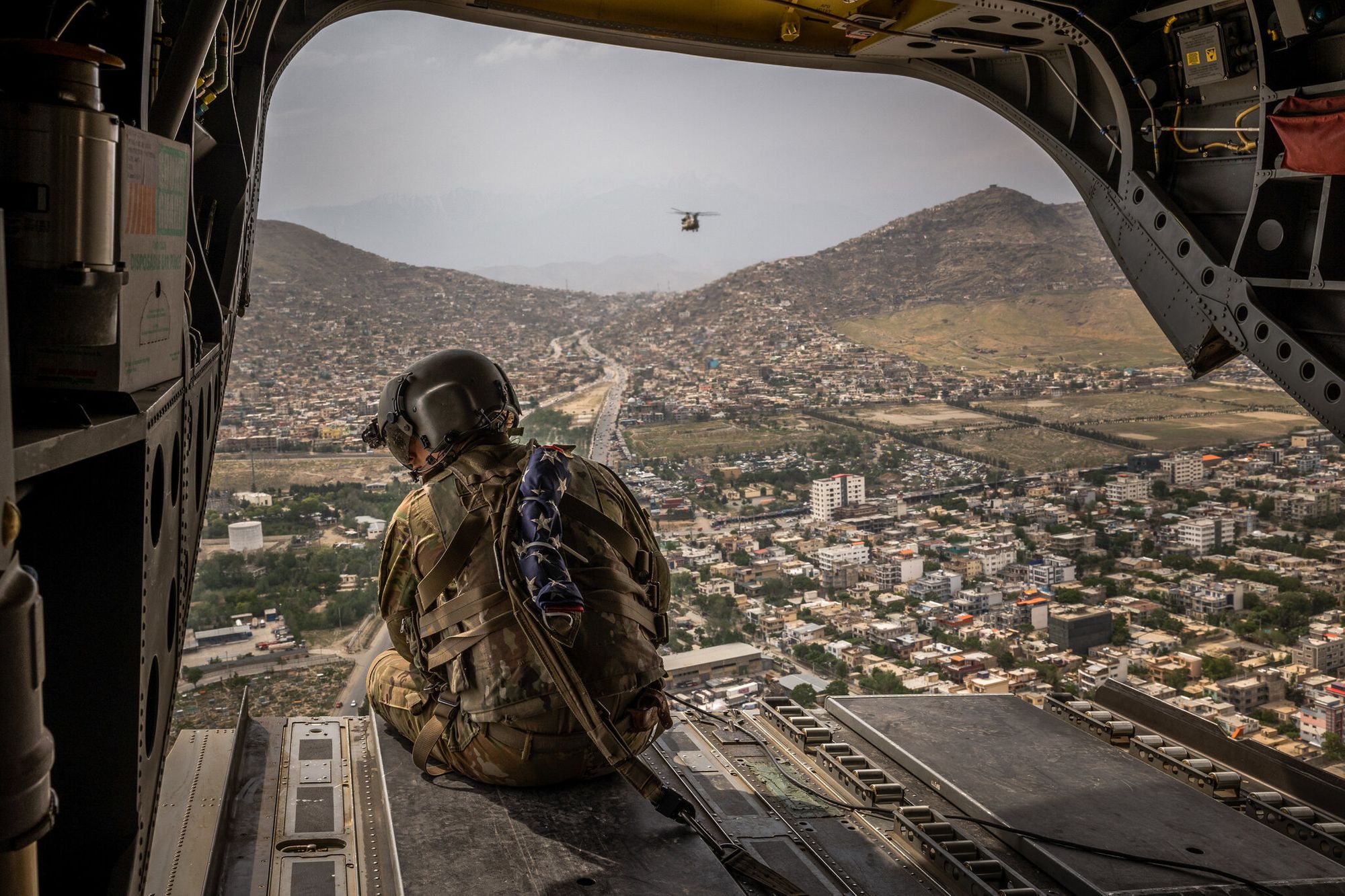 Photo of soldier in military aircraft, as seen in the New York Times article “Day 1 of the End of the U.S. War in Afghanistan“