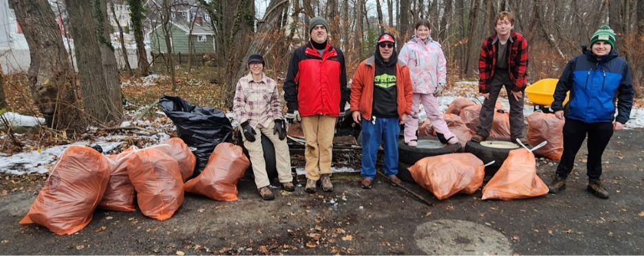 A group of people standing in front of garbage bags

AI-generated content may be incorrect.